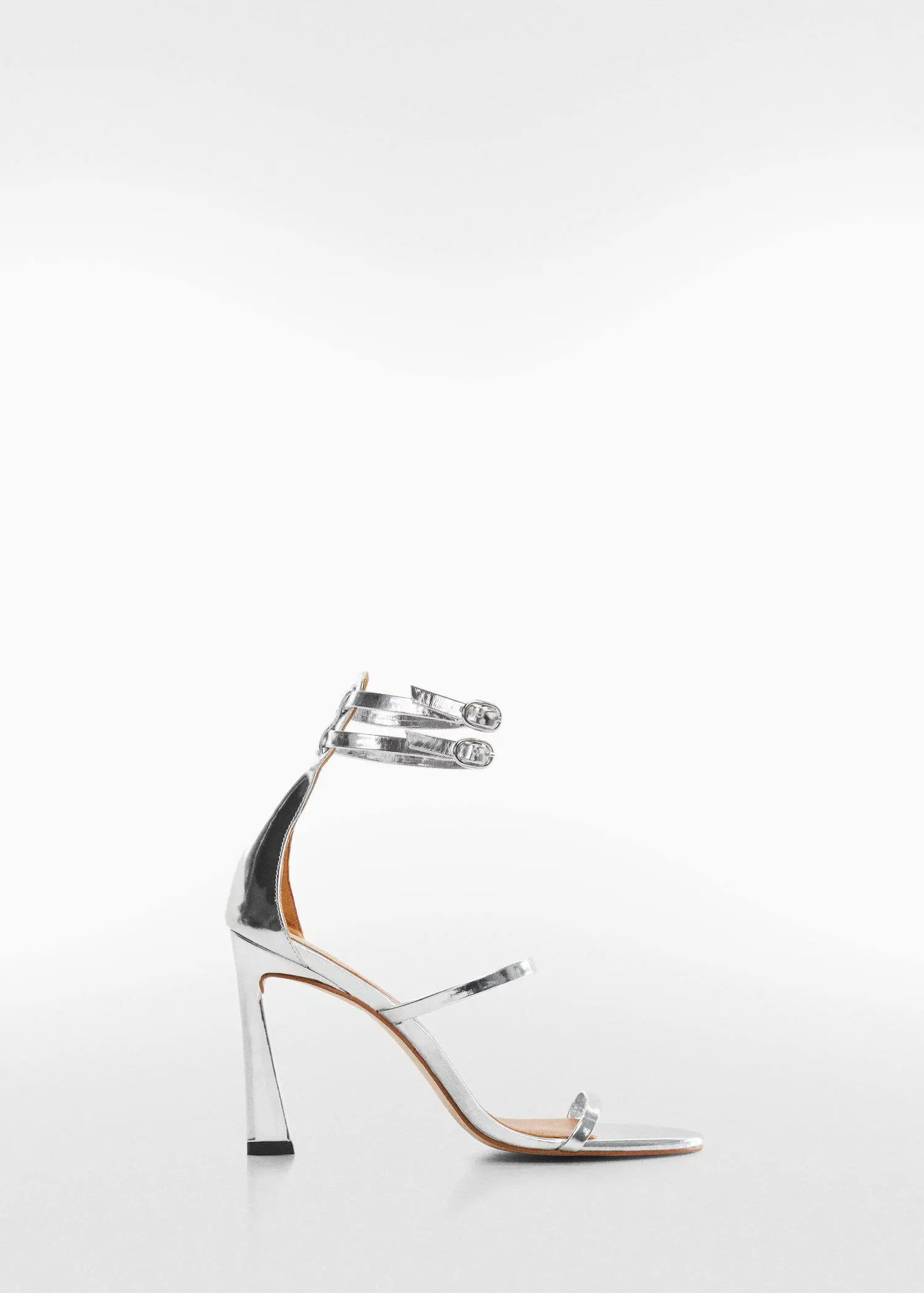 Mango Leather ankle-cuff sandals. a pair of silver high heeled shoes on a white background 