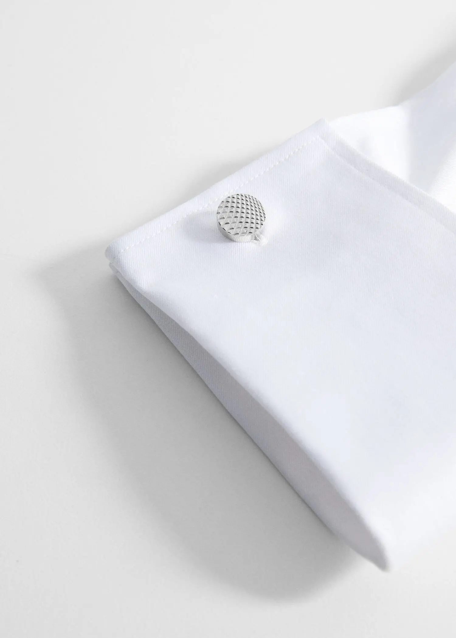 Mango 100% copper geometric cufflinks. a close-up of a button on top of a white shirt. 