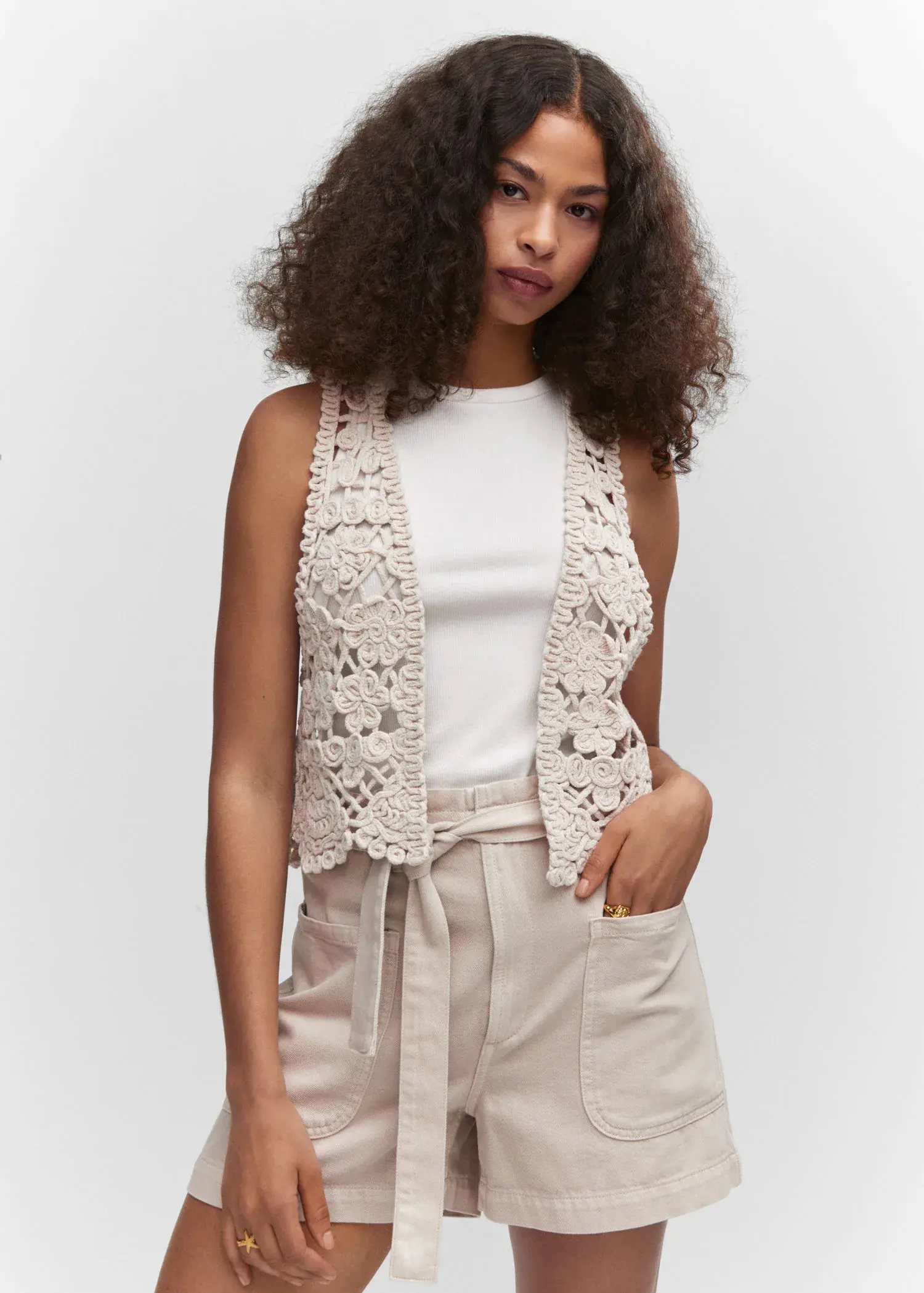 Mango Fringed vest. a woman wearing a white shirt and a white vest. 