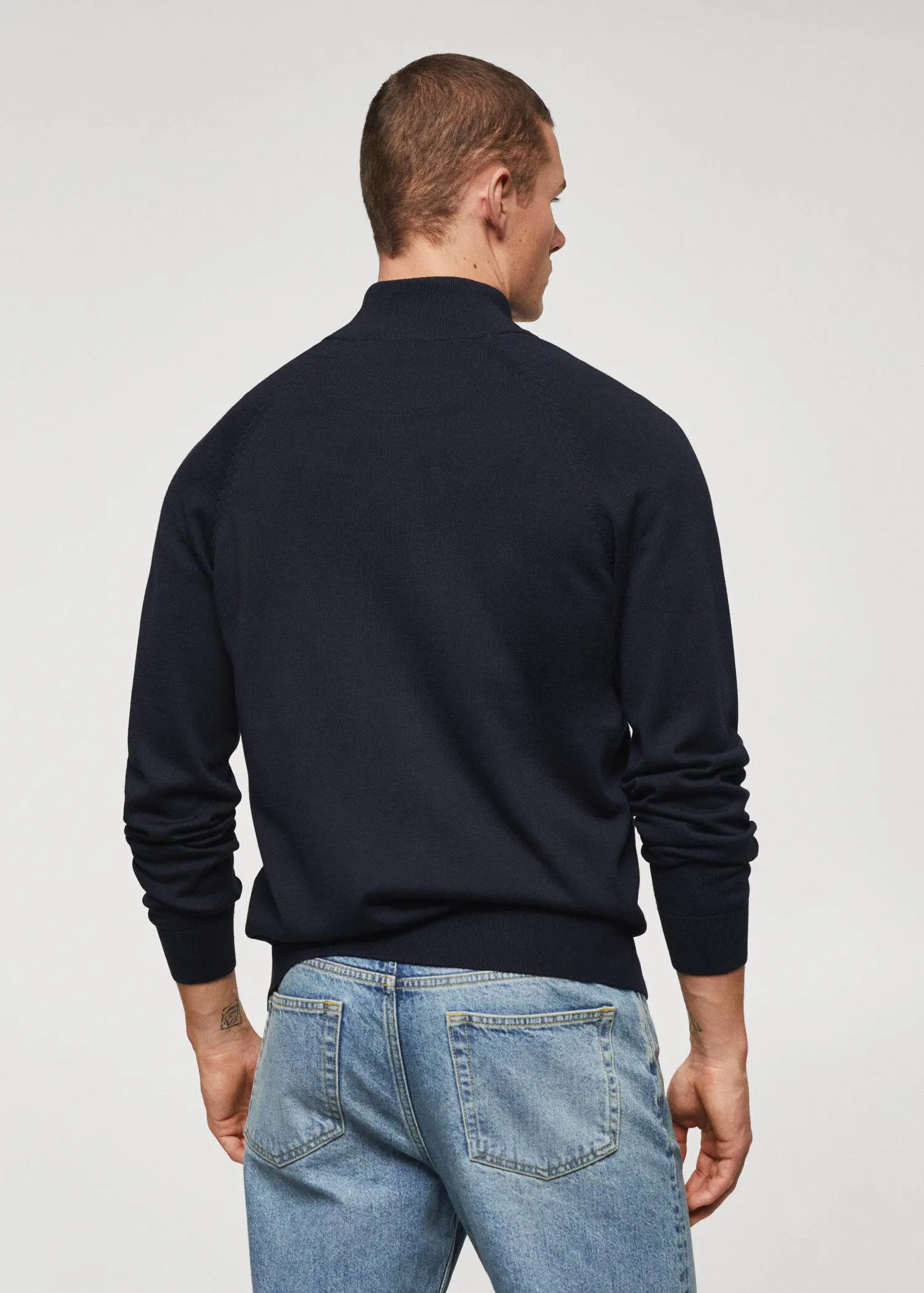Mango Zipped cotton cardigan. a man wearing jeans and a black sweater. 