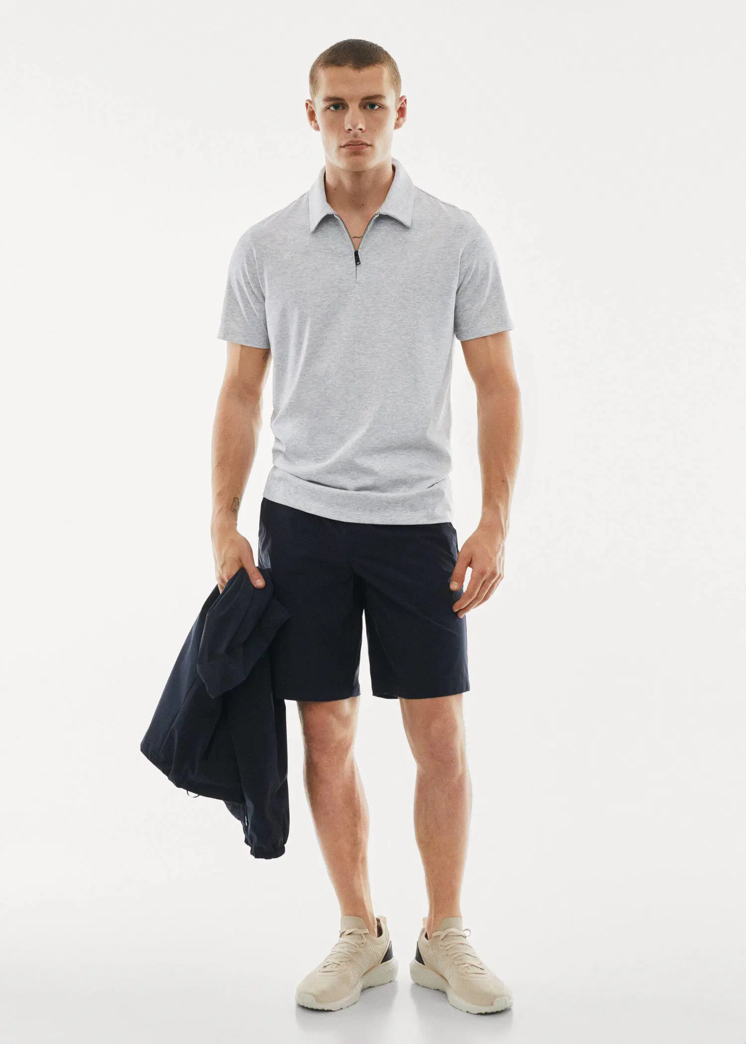 Mango Zip cotton polo shirt. a young man in shorts and a polo shirt. 