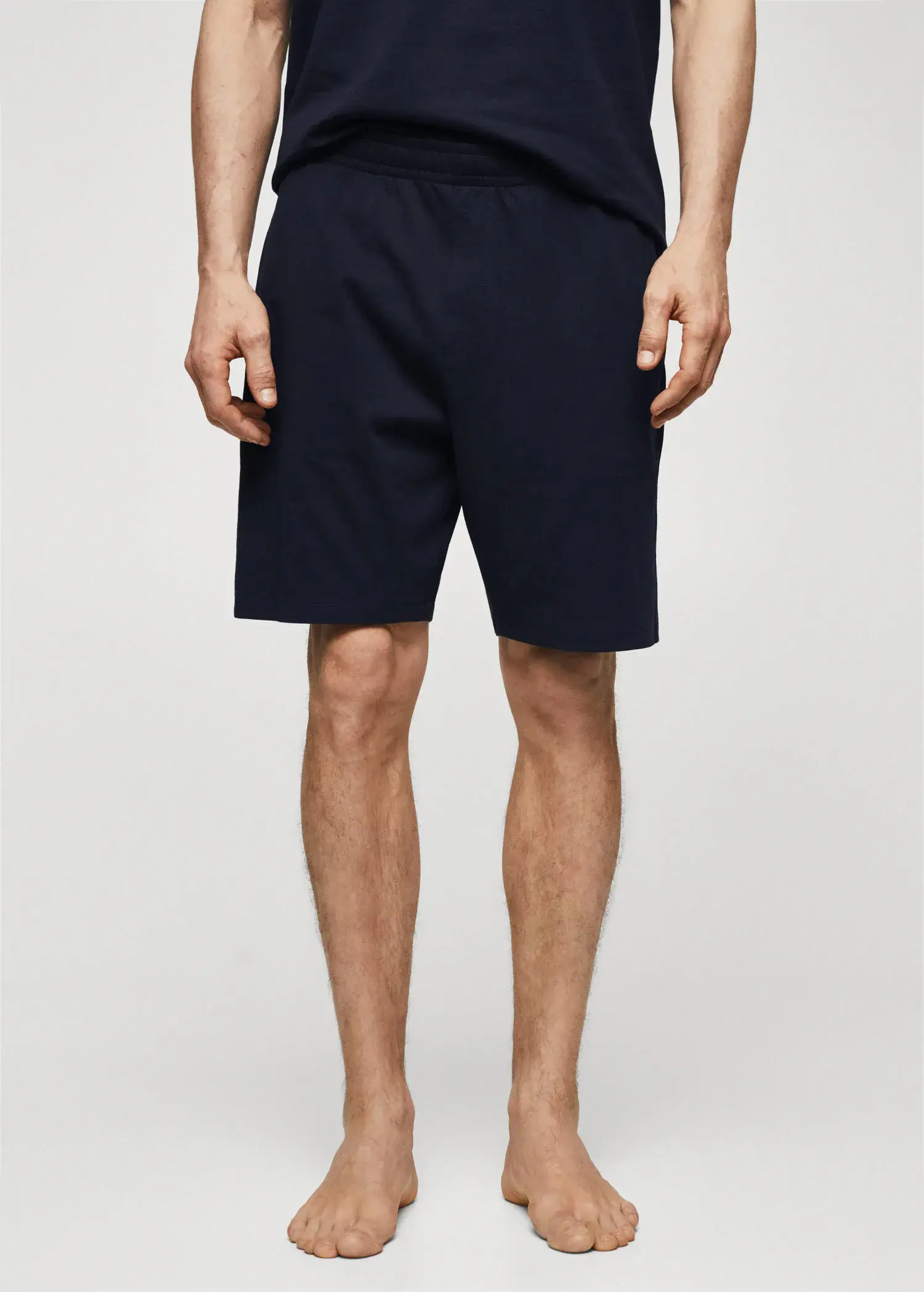 Mango Cotton pyjama shorts pack. a man in black shorts is standing up. 