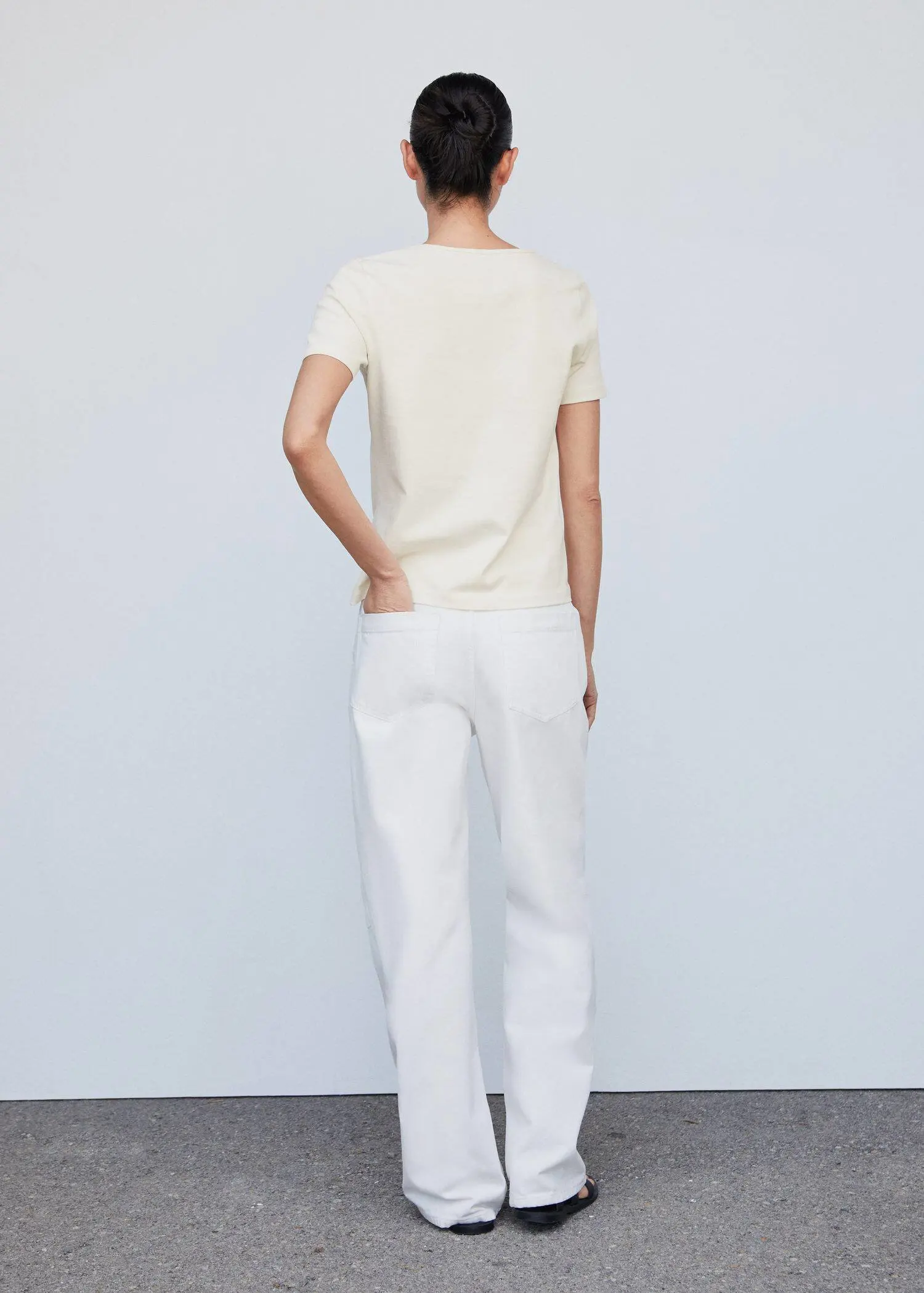 Mango Cotton t-shirt with pucker detail. a person standing in front of a white wall 