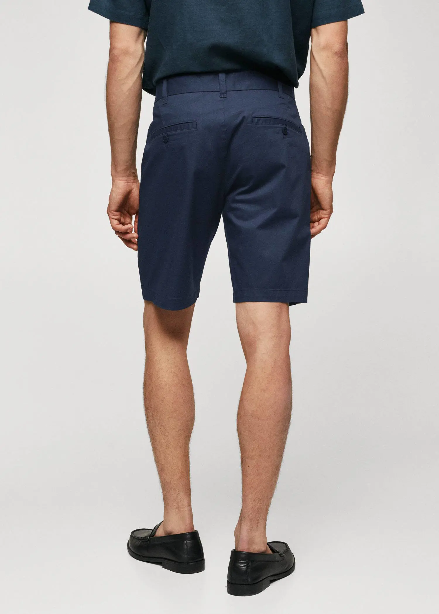 Mango Chino Bermuda shorts. a man wearing a pair of navy blue shorts. 