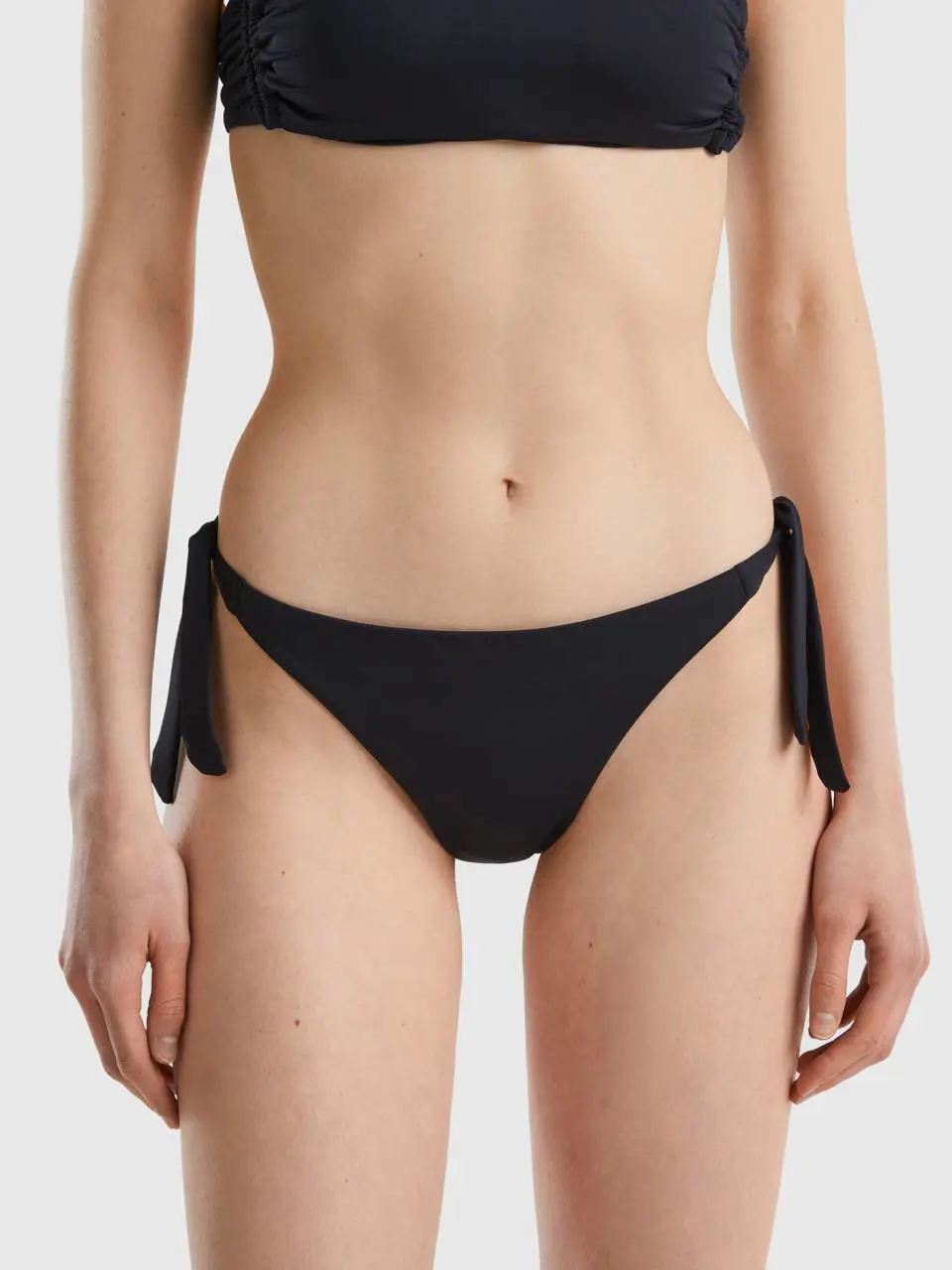 Benetton swim bottoms in econyl® with bows. 1
