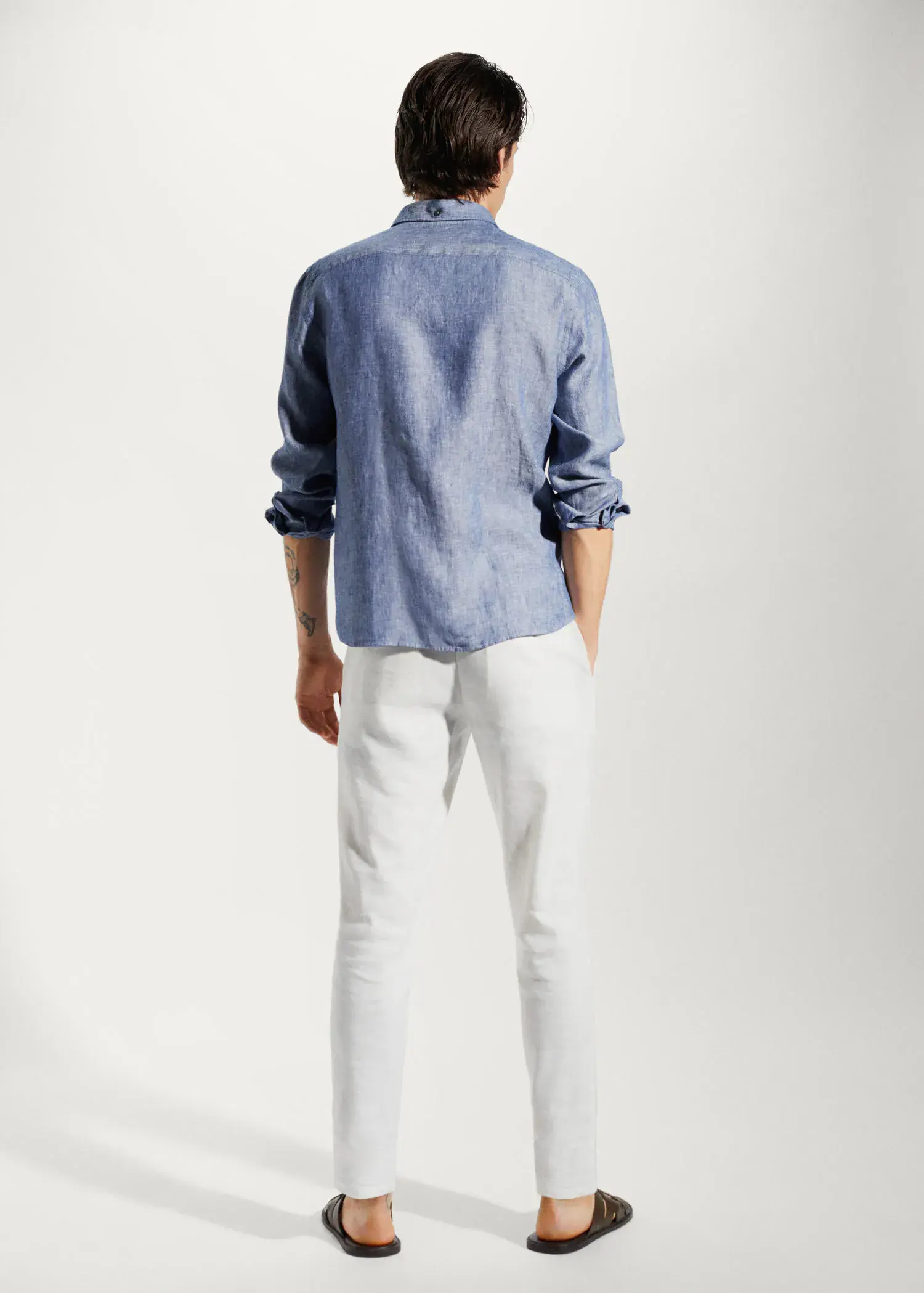 Mango 100% linen slim-fit shirt. a man wearing a blue shirt and white pants. 