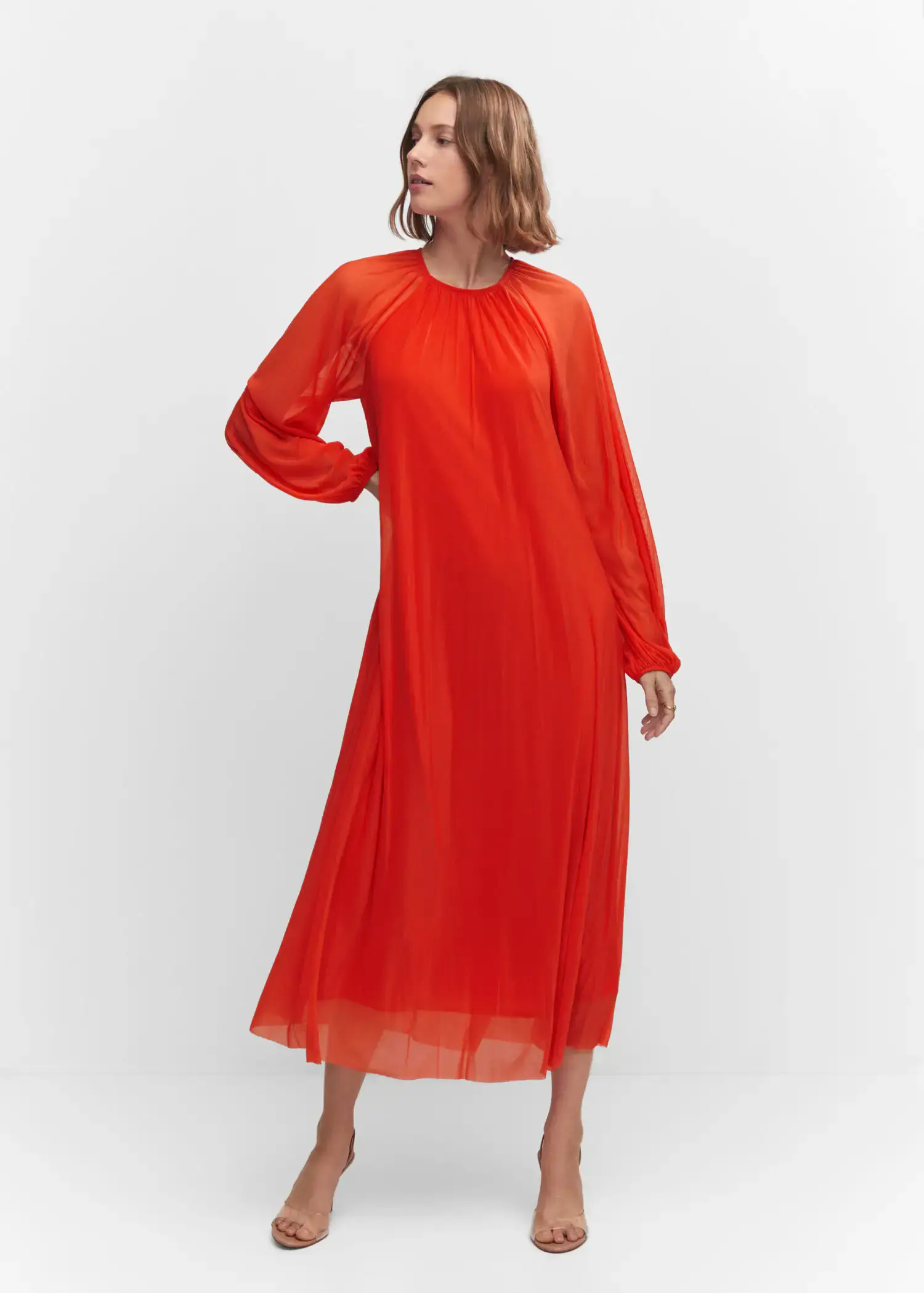 Mango Puffed sleeves dress. a woman wearing a red dress standing in front of a white wall. 