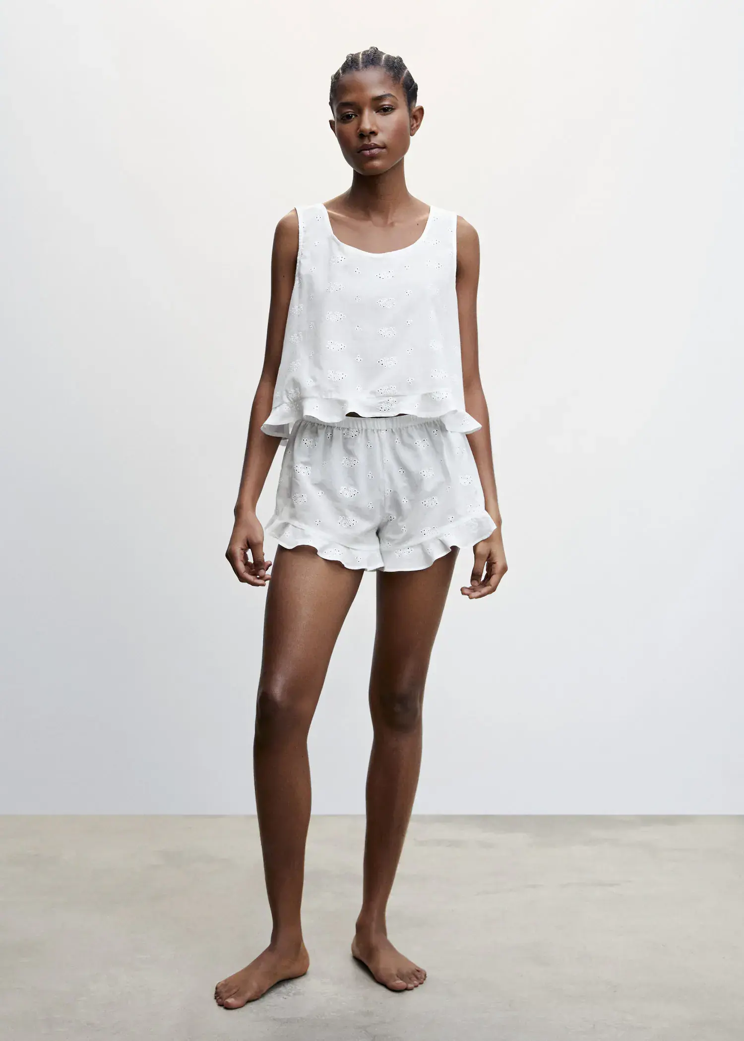 Mango Pyjama shorts with openwork detail. a woman in white shorts and a tank top. 