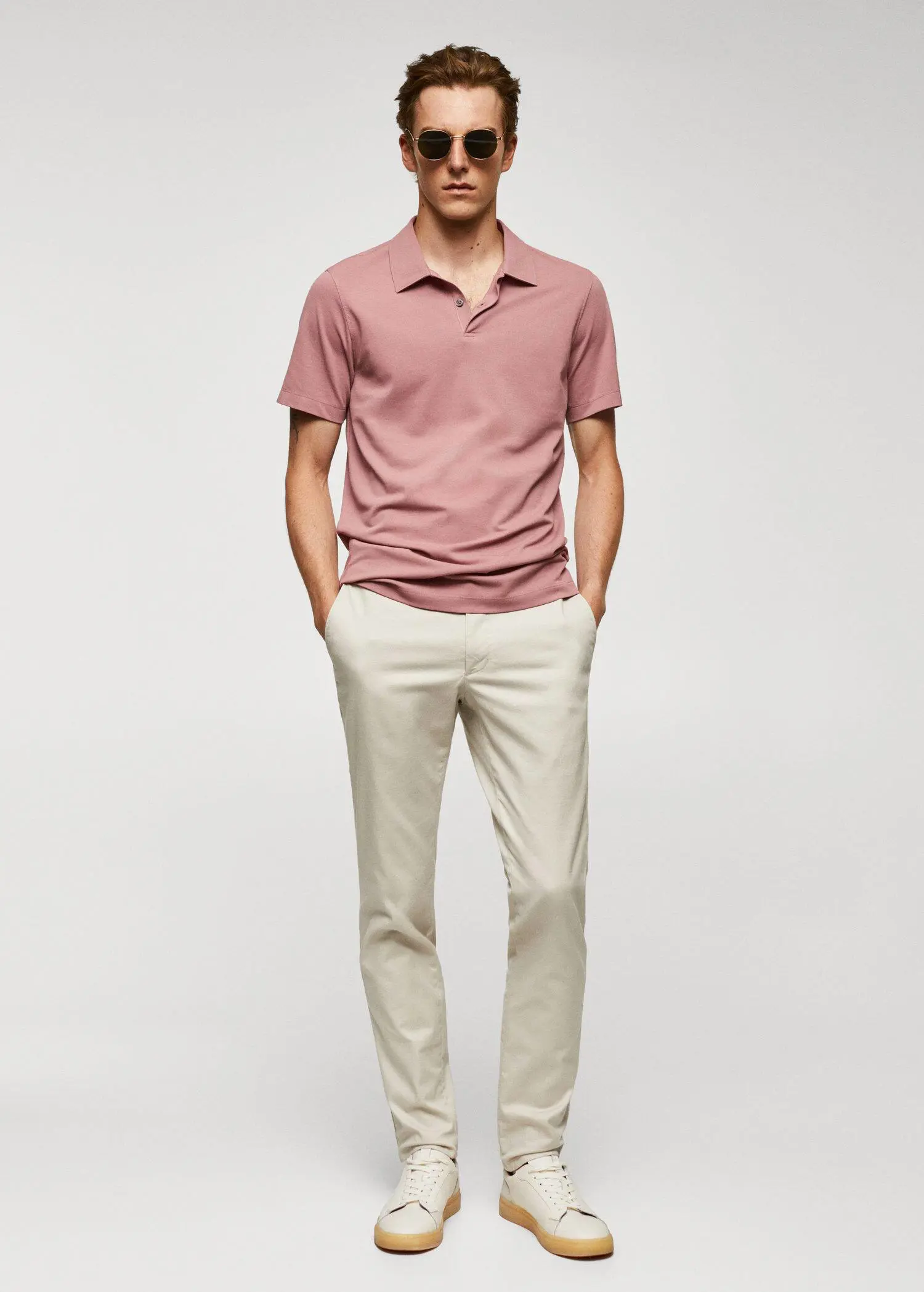 Mango Slim-fit textured cotton polo shirt. a man in a pink shirt and white pants. 