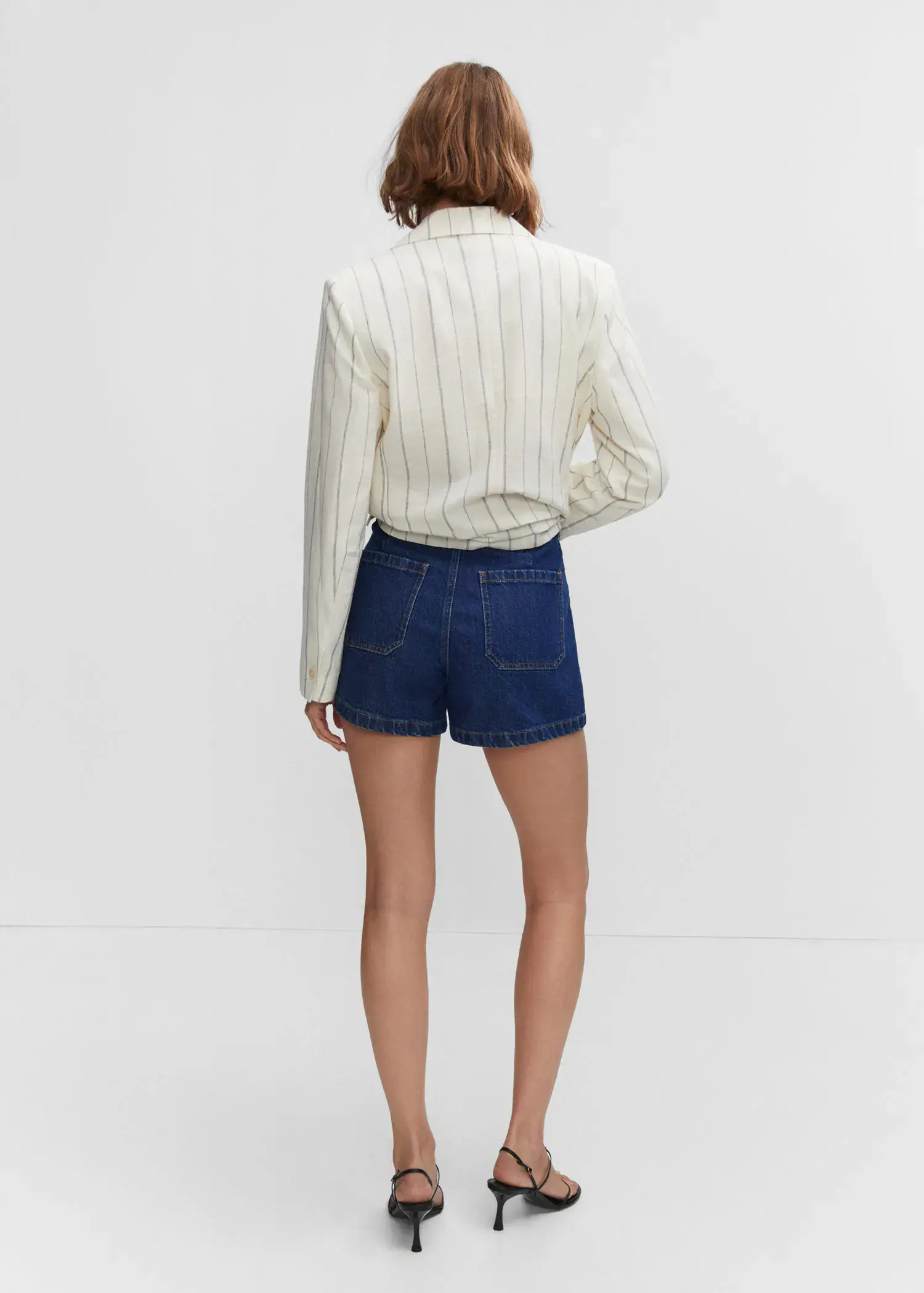 Mango Denim shorts with pockets. a woman wearing a white shirt and blue shorts. 