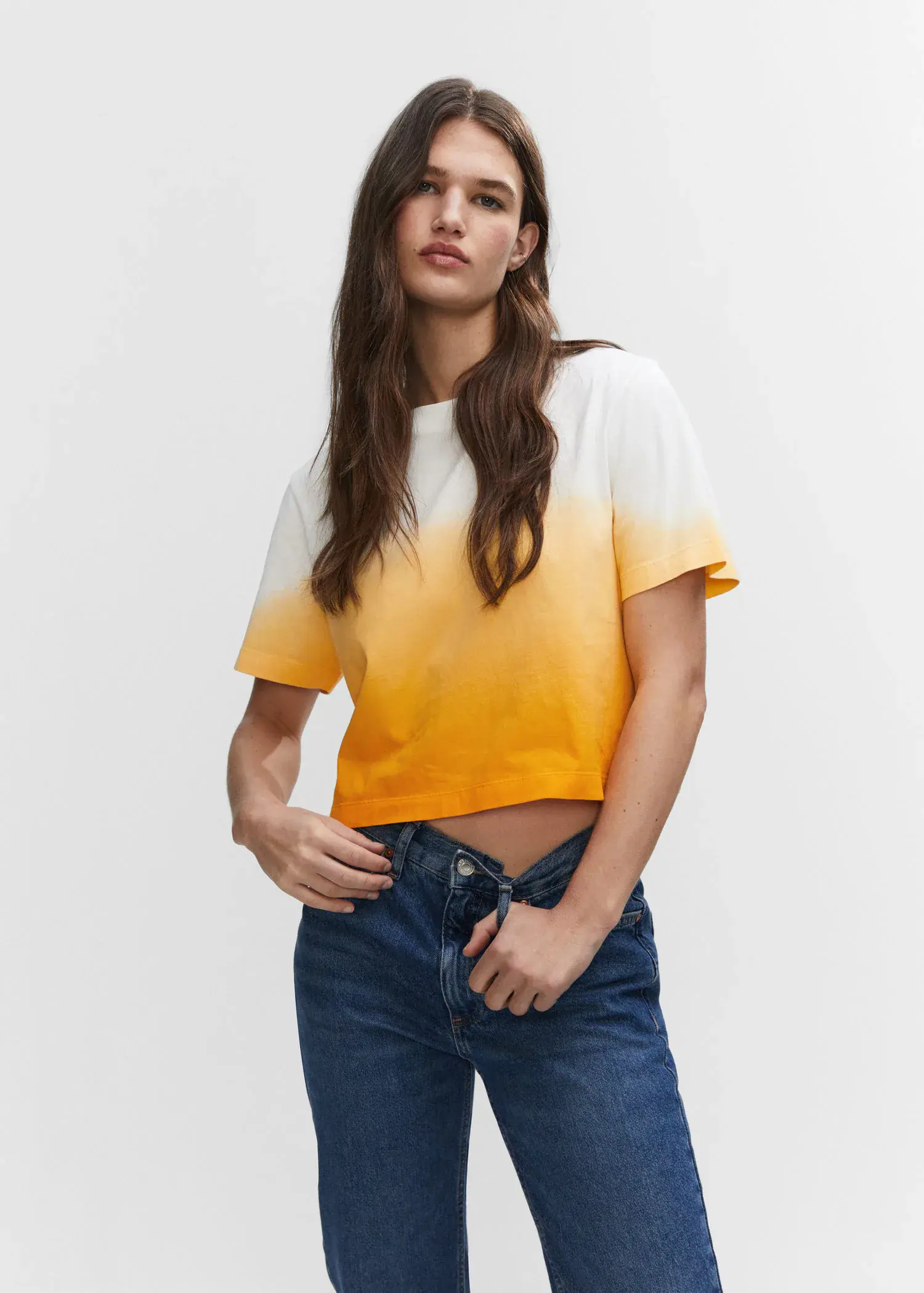 Mango Cotton ombré t-shirt. a woman wearing a yellow and white shirt and jeans. 