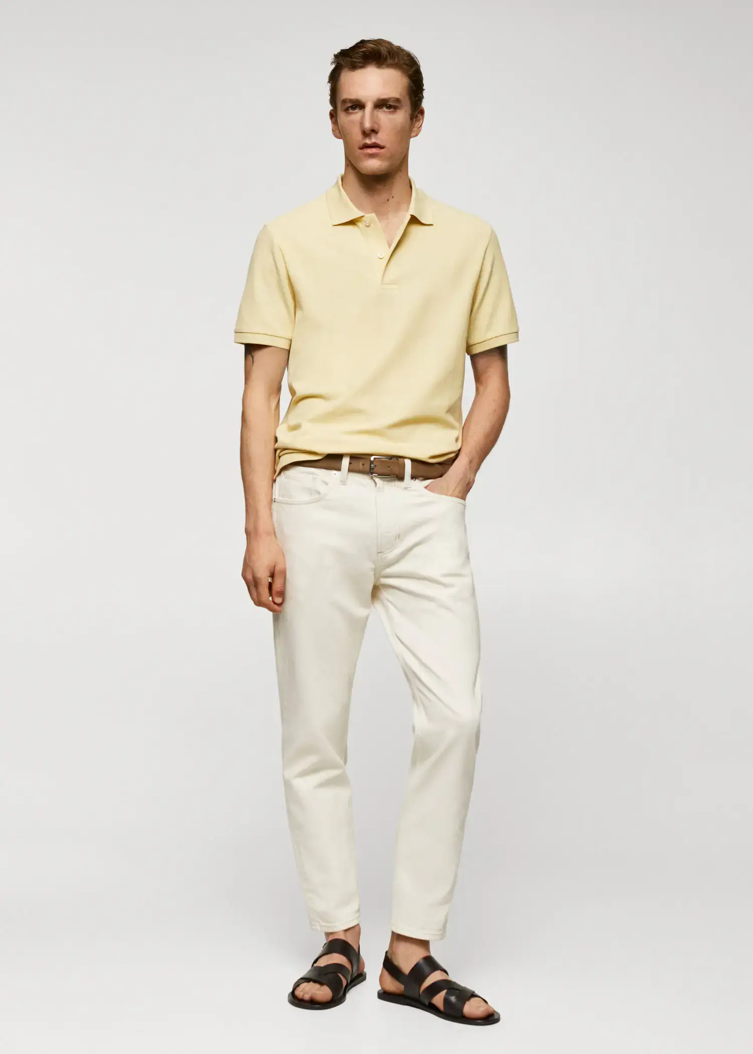 Mango 100% cotton pique polo shirt. a man in a yellow polo shirt and white pants. 