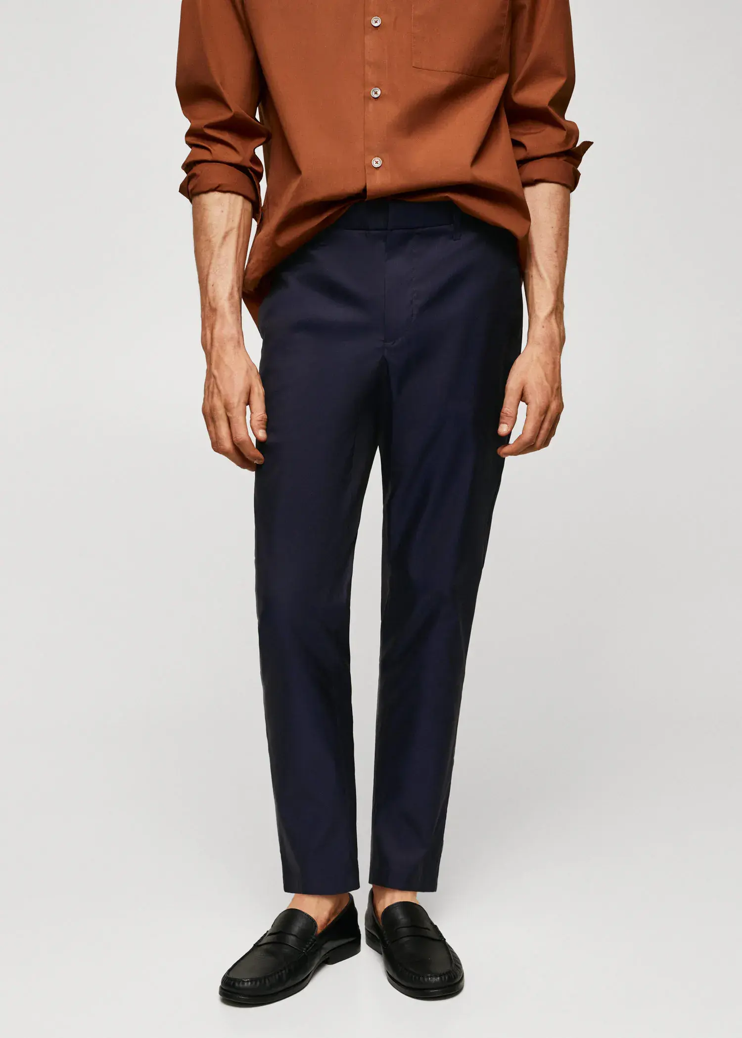 Mango Slim-fit cotton trousers. a man wearing a brown shirt and black pants. 