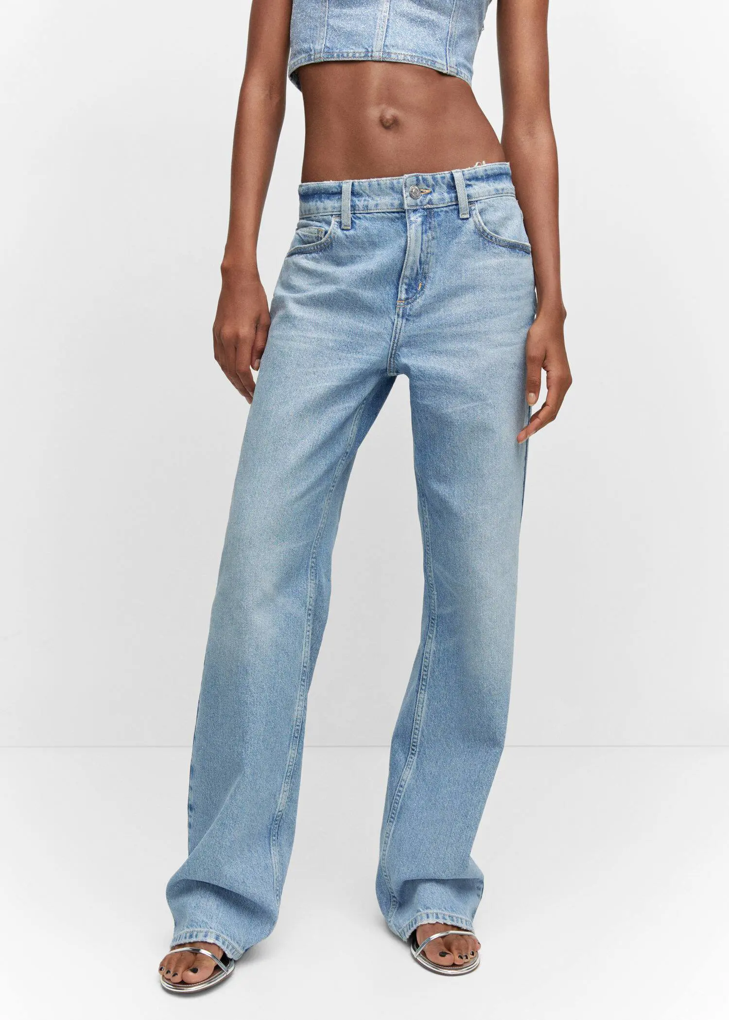 Mango Shiny straight-leg jeans. a woman wearing a pair of light blue jeans. 