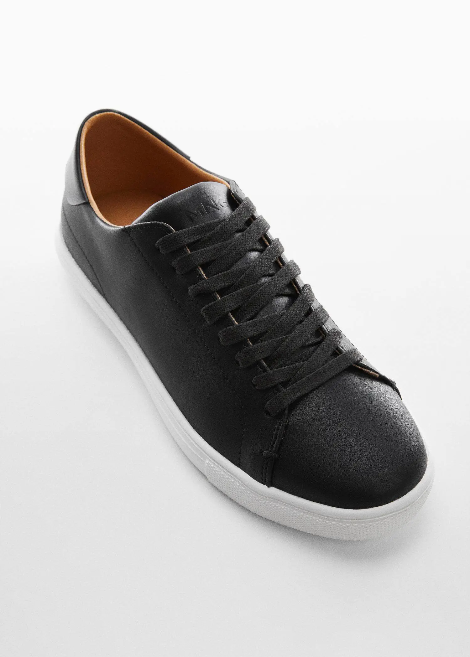 Mango Monocoloured leather sneakers. a pair of black shoes on a white surface. 