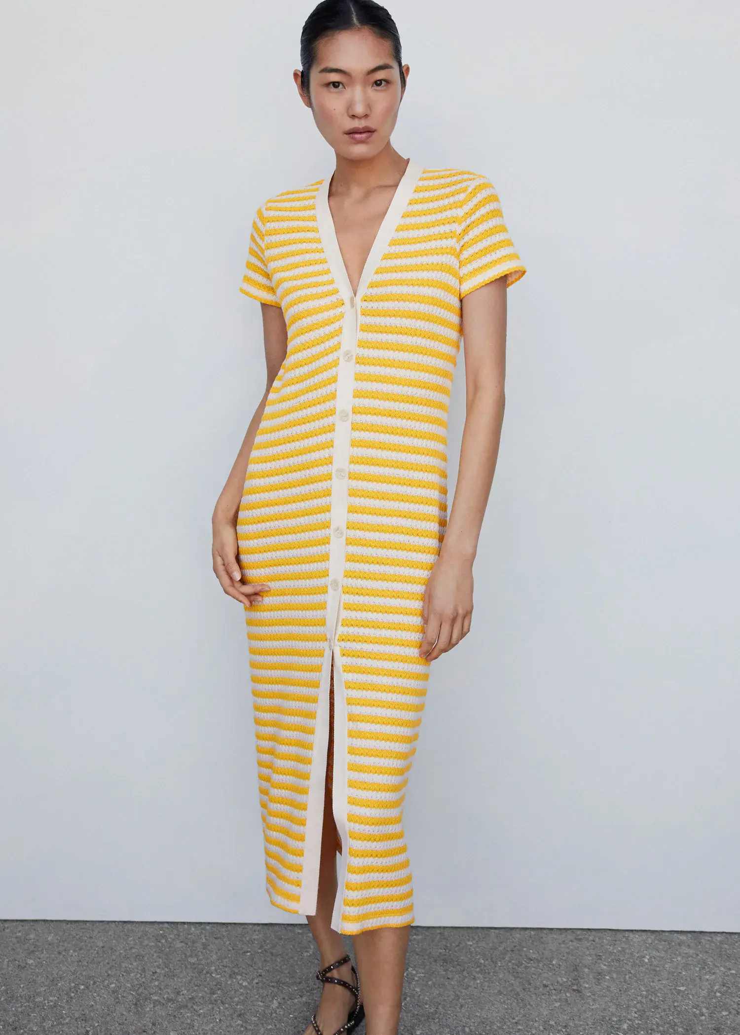 Mango Striped jersey dress. a woman wearing a yellow and white striped dress. 
