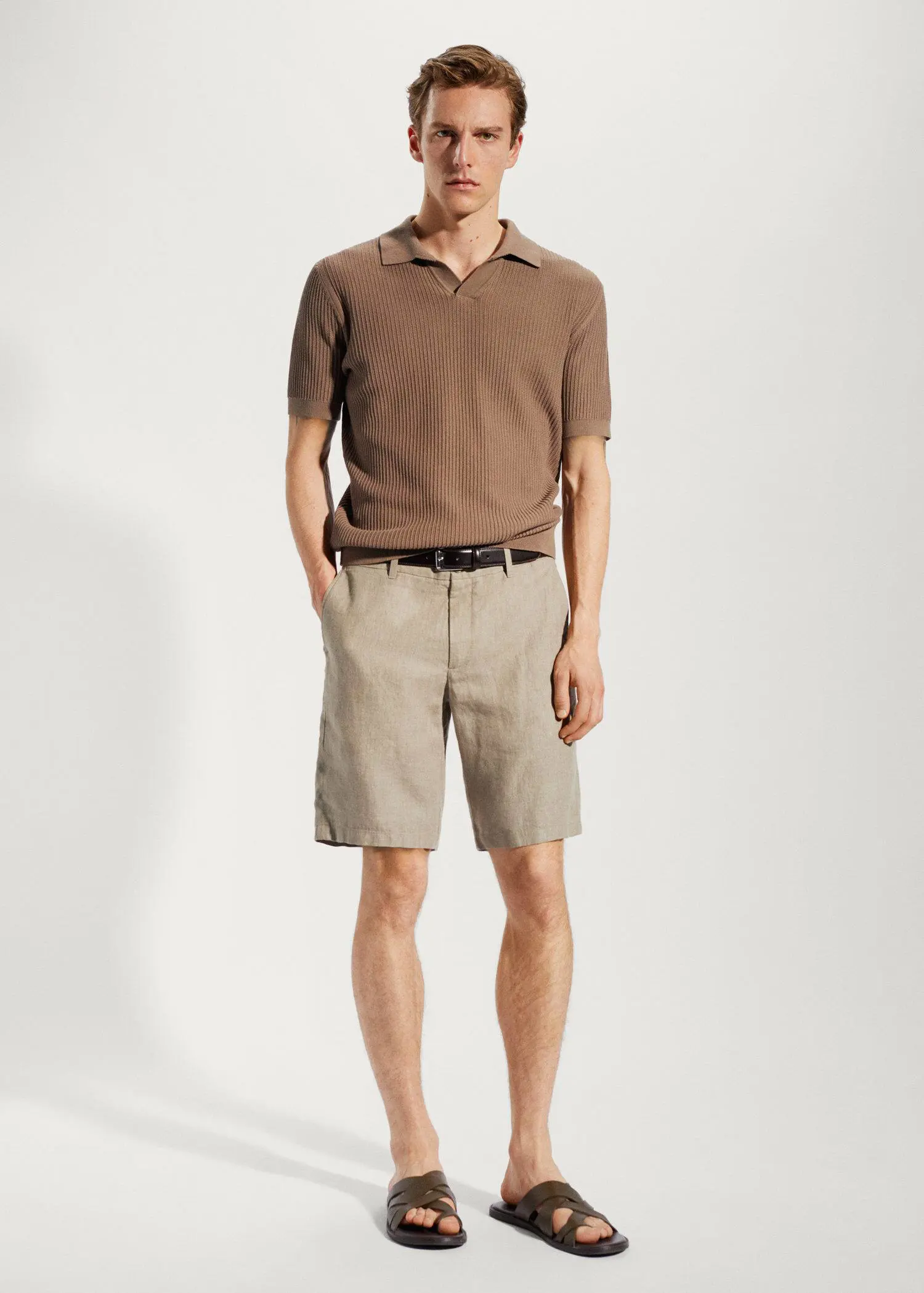 Mango 100% linen shorts. a man in a brown polo shirt and beige shorts. 