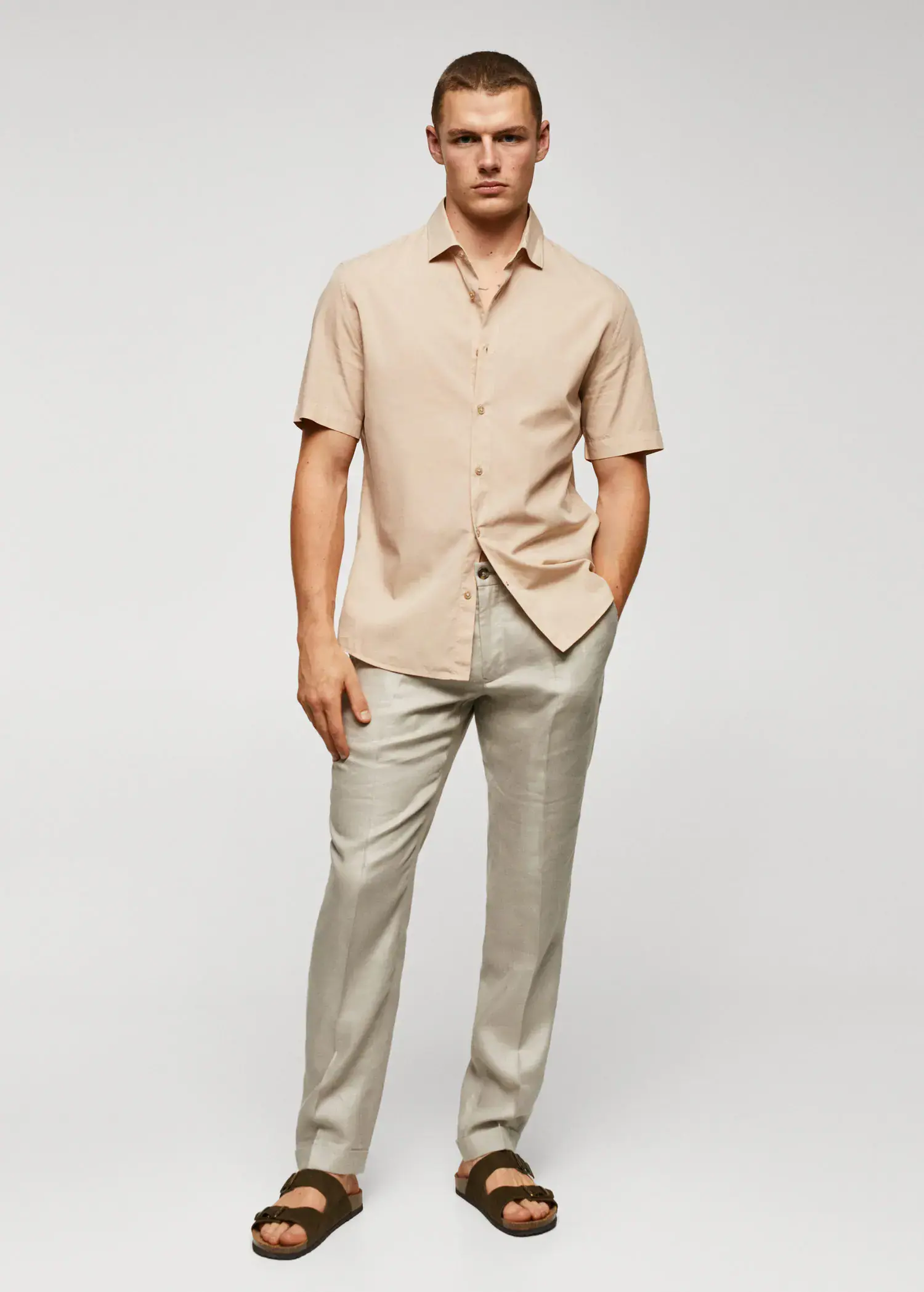 Mango Lightweight cotton shirt . a man in a tan shirt and silver pants. 