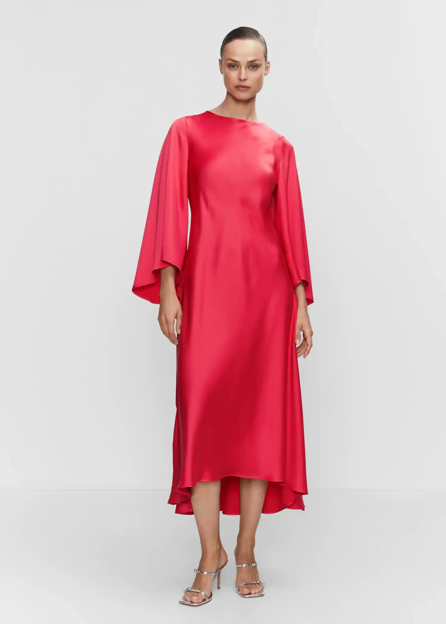 Mango Flared-sleeve satin dress. a woman wearing a red dress standing in front of a white wall. 