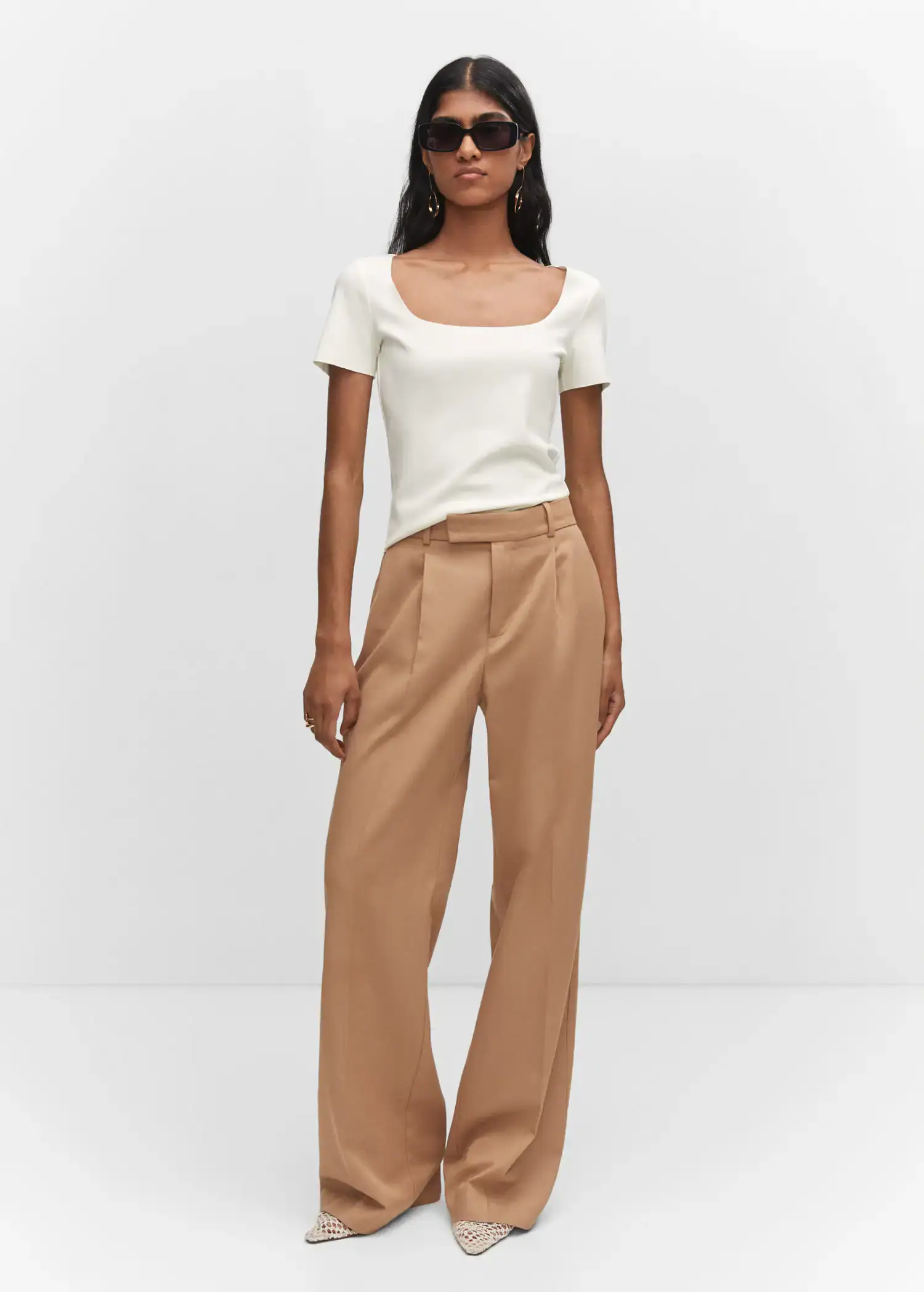Mango Square neck t-shirt. a woman in a white top and brown pants. 
