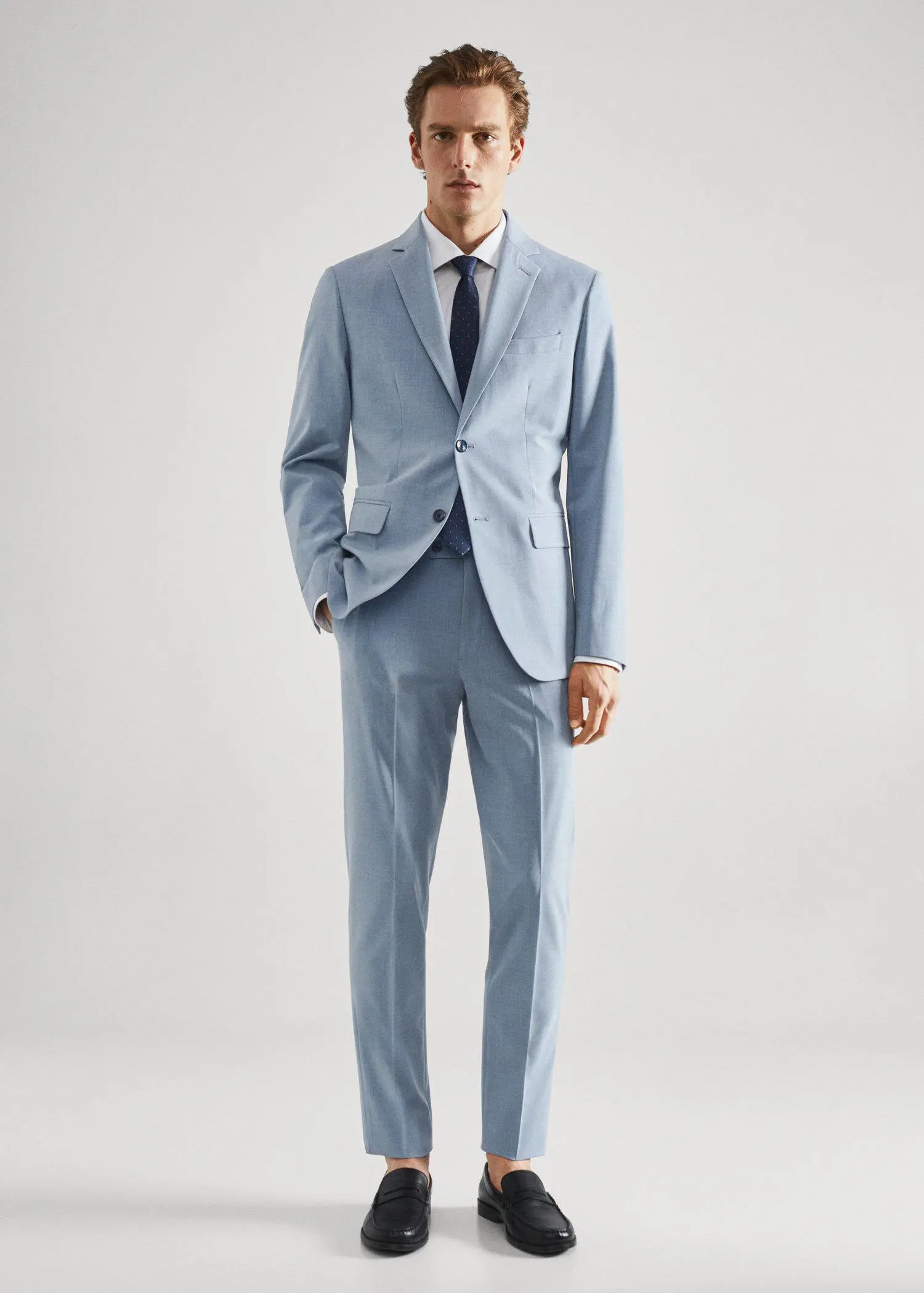 Mango Stretch fabric slim-fit suit pants. a man in a suit and tie standing in front of a white wall. 