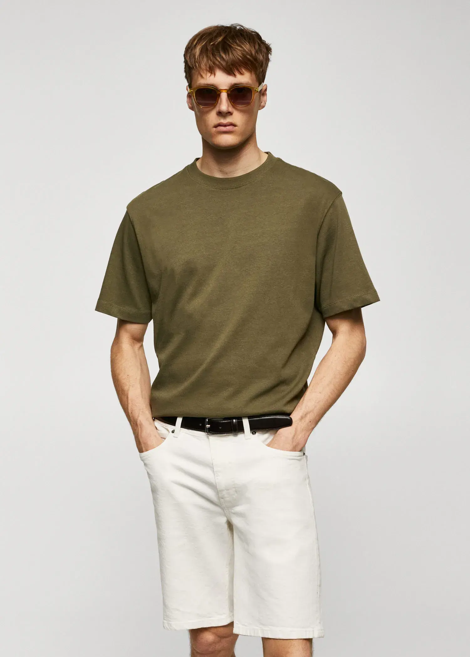 Mango Basic 100% cotton relaxed-fit t-shirt. a man wearing a green shirt and white pants. 