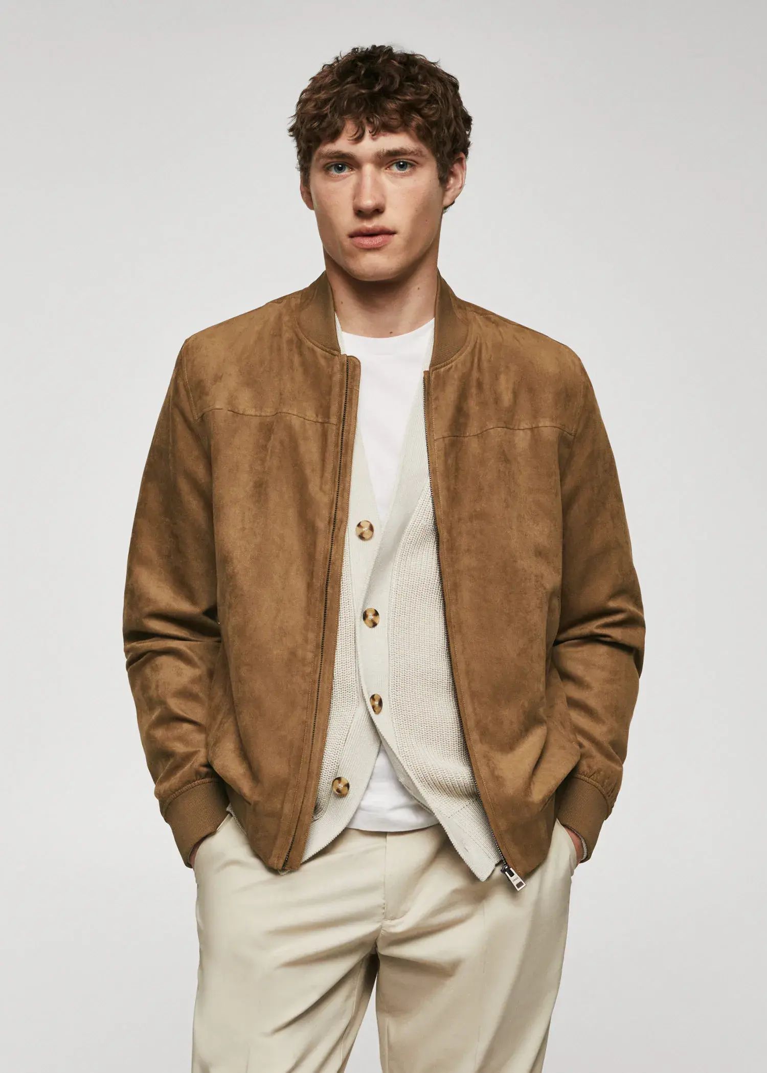 Mango Suede-effect bomber jacket. a man in a brown jacket is posing for a picture. 