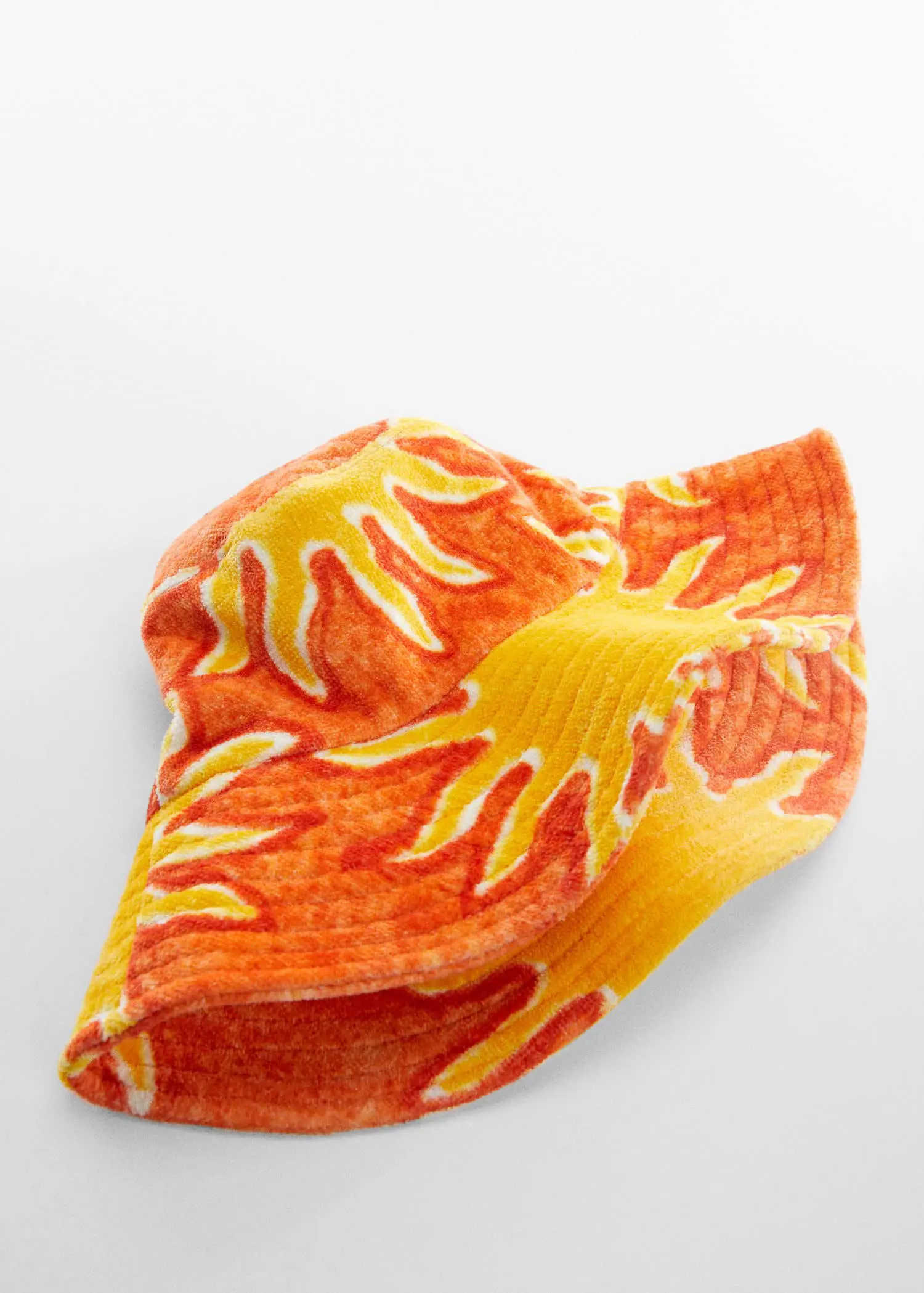 Mango Printed terry cloth bucket hat. an orange and yellow object on top of a white surface. 