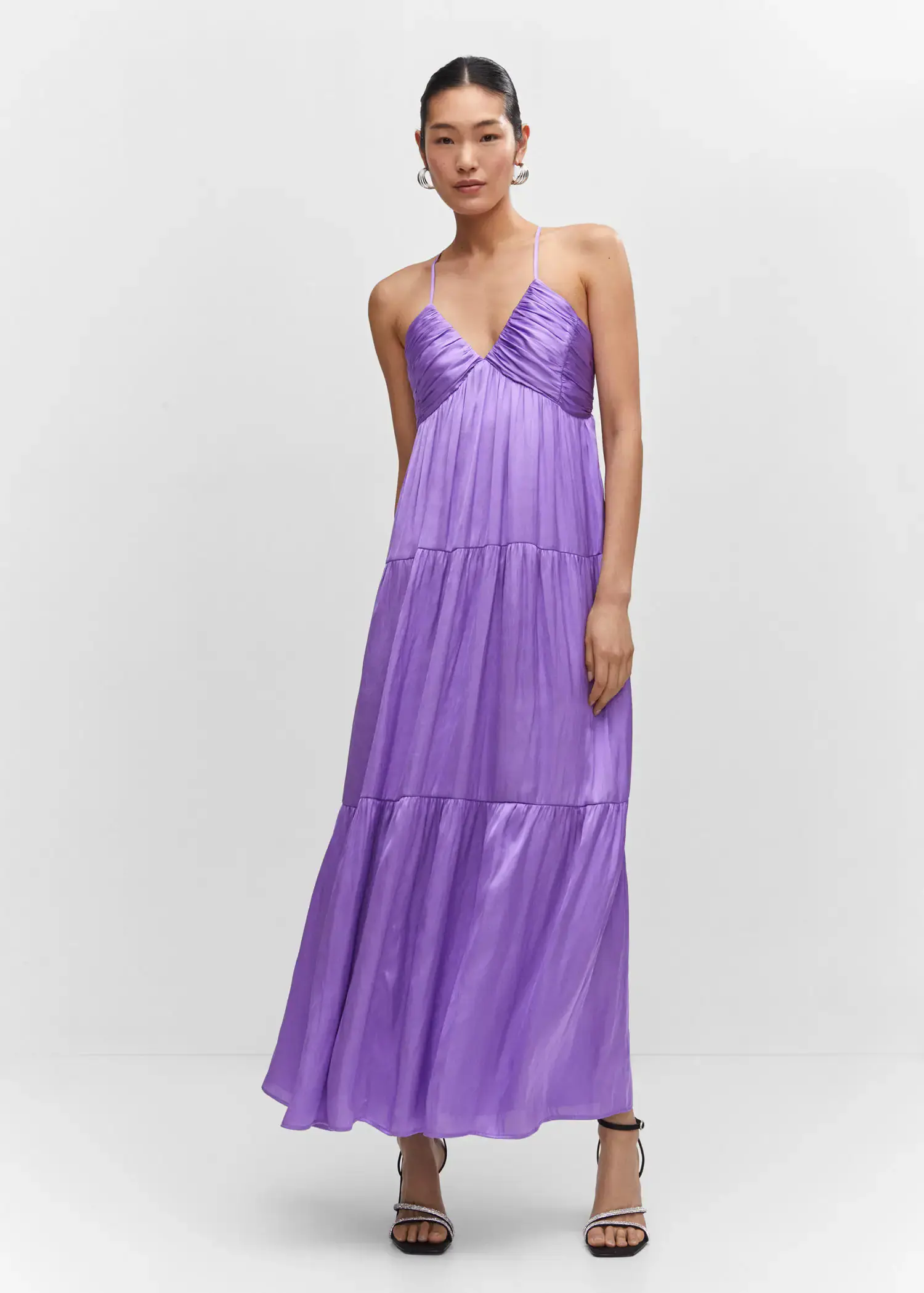 Mango Ruched satin dress. a woman wearing a long purple dress standing next to a wall. 