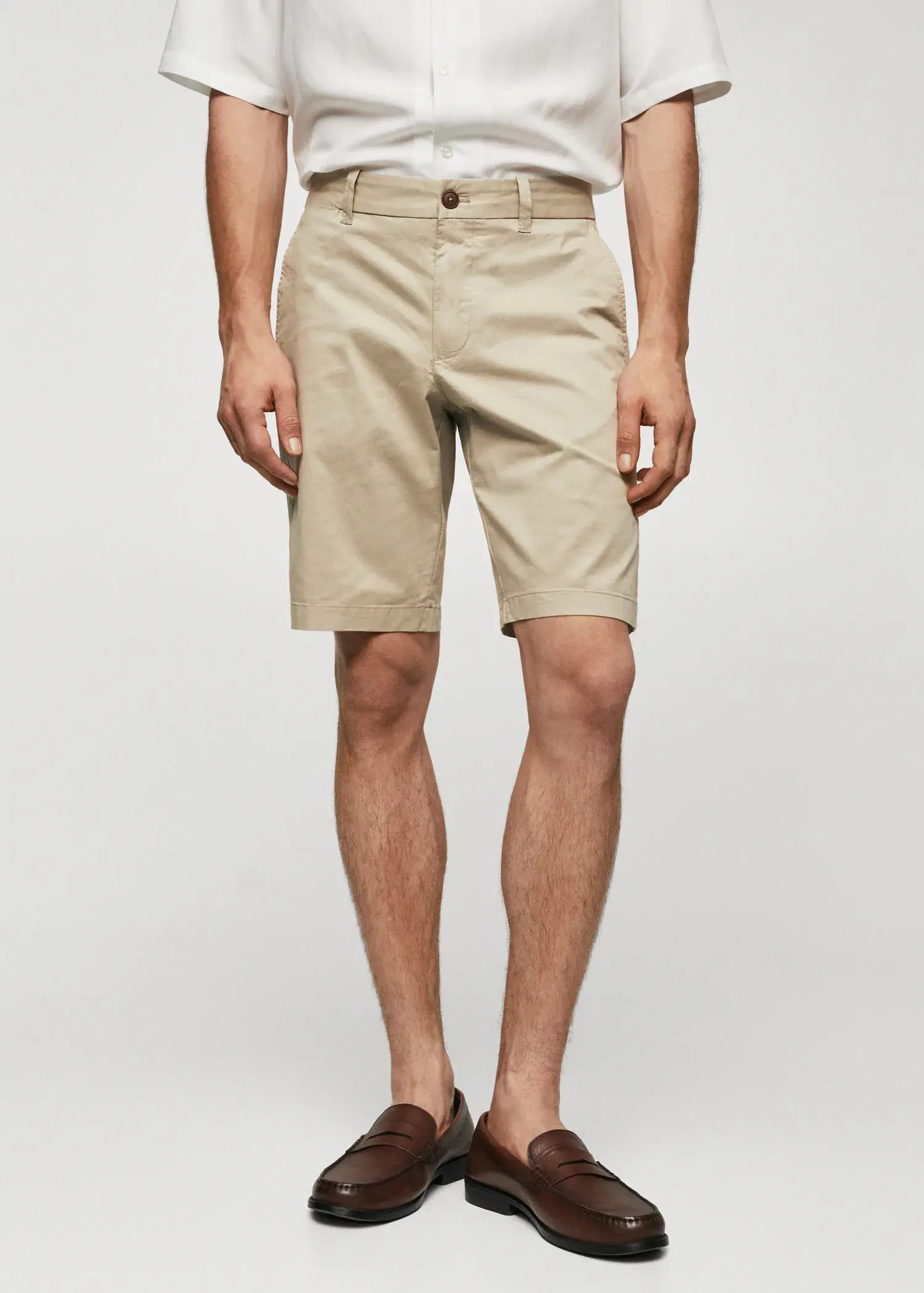 Mango Chino Bermuda shorts. a man wearing a pair of khaki shorts. 