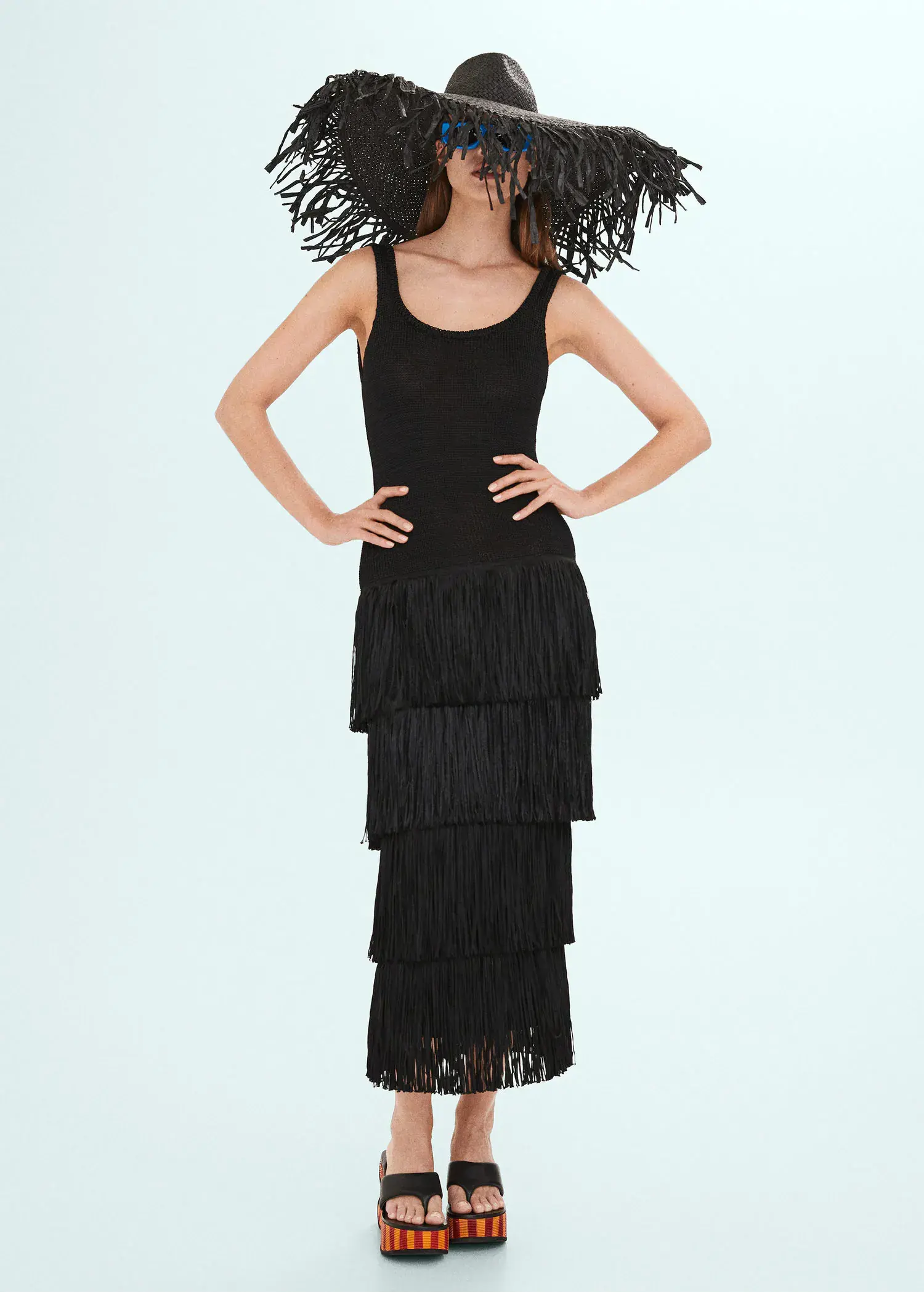Mango Knitted dress with fringe design. a woman wearing a black dress with fringes. 