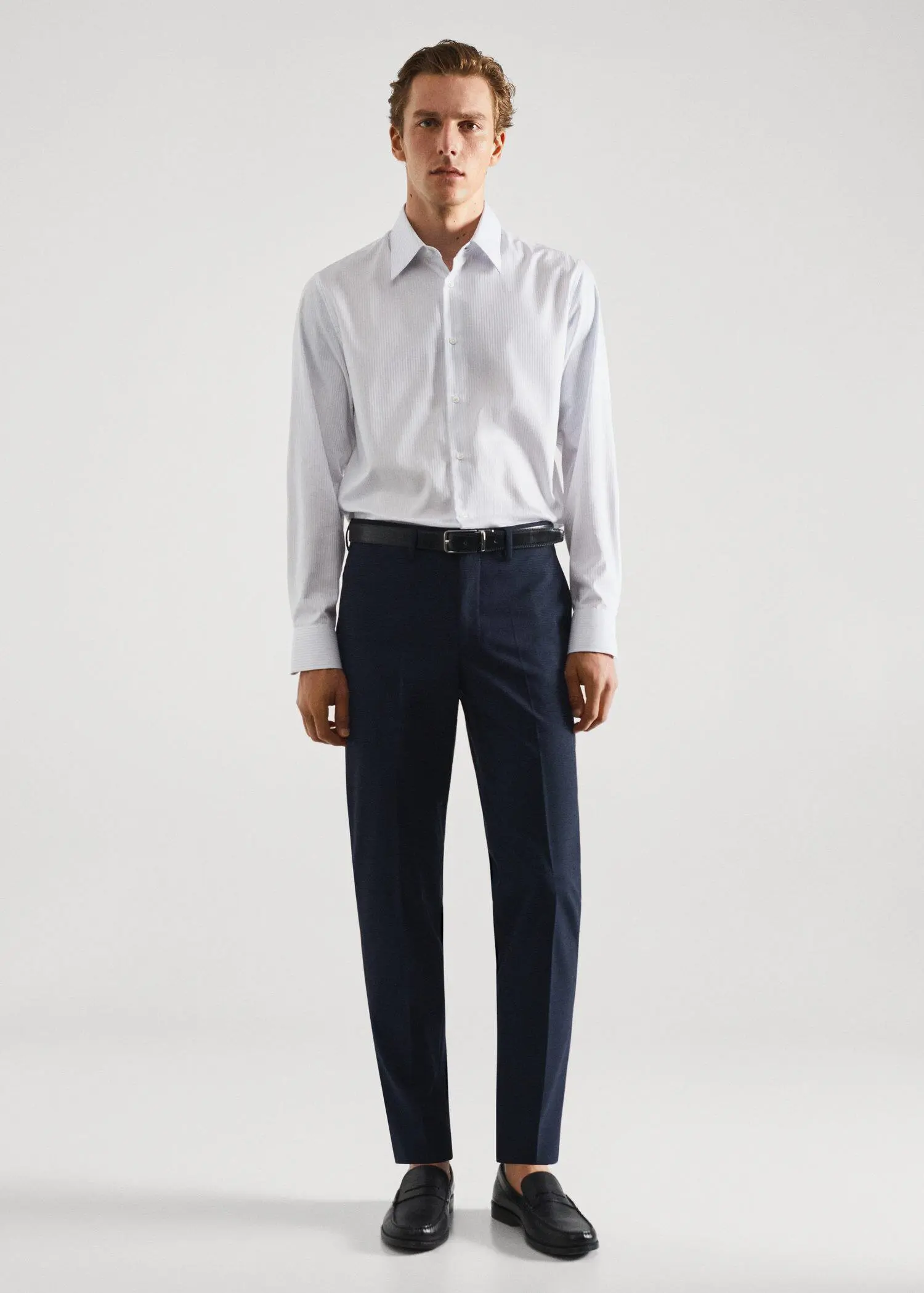 Mango Slim-fit striped cotton twill suit shirt. a man in a white shirt and black pants. 