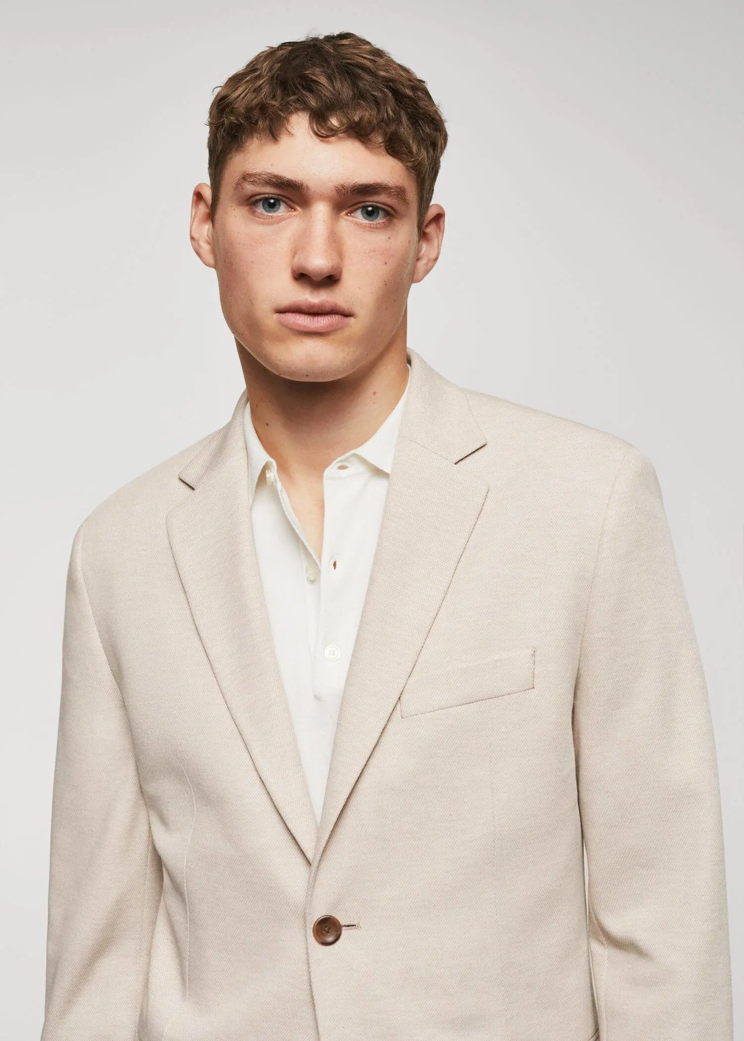 Mango Slim fit microstructure blazer. a man wearing a suit and white shirt. 