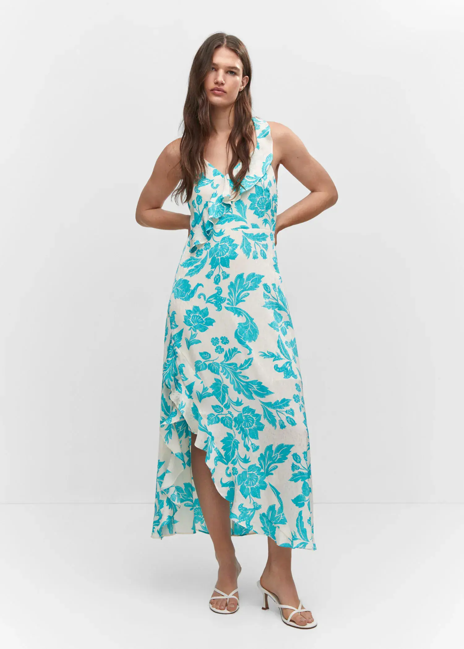 Mango Ruffles slit dress. a woman in a blue floral dress standing in front of a wall. 