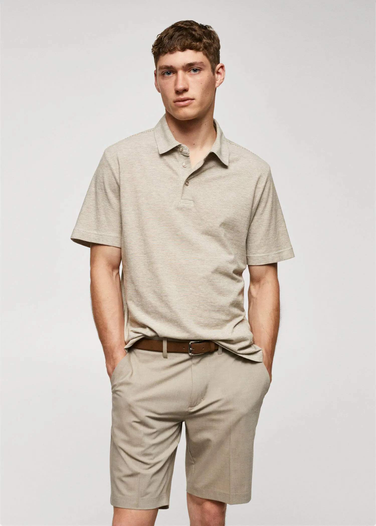 Mango 100% cotton polo shirt with striped structure. a man in a beige shirt and a brown belt. 