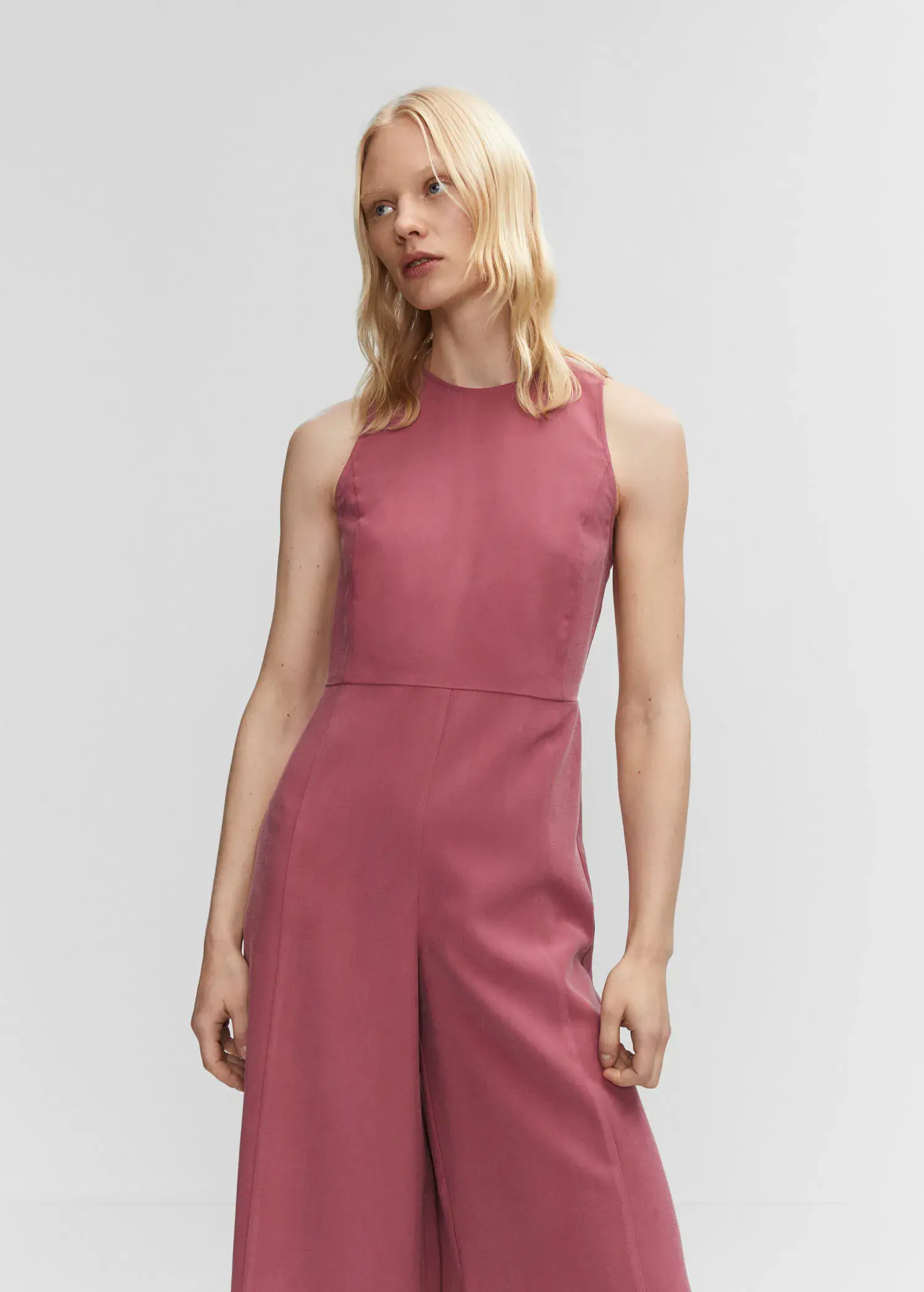 Mango Cropped jumpsuit with straps. a woman wearing a pink dress standing in front of a wall. 