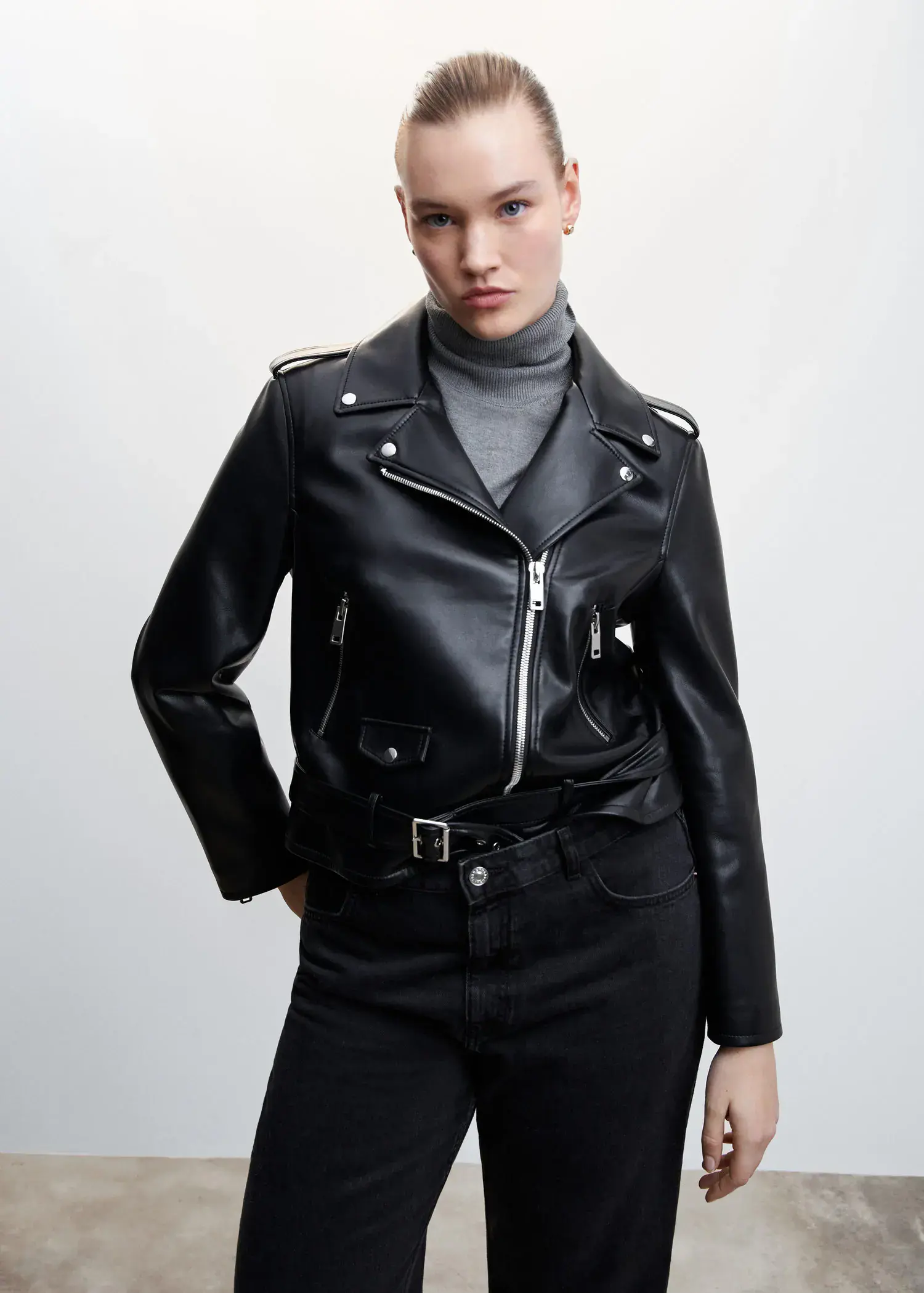 Mango Faux-leather biker jacket. a woman wearing a black leather jacket and black pants. 