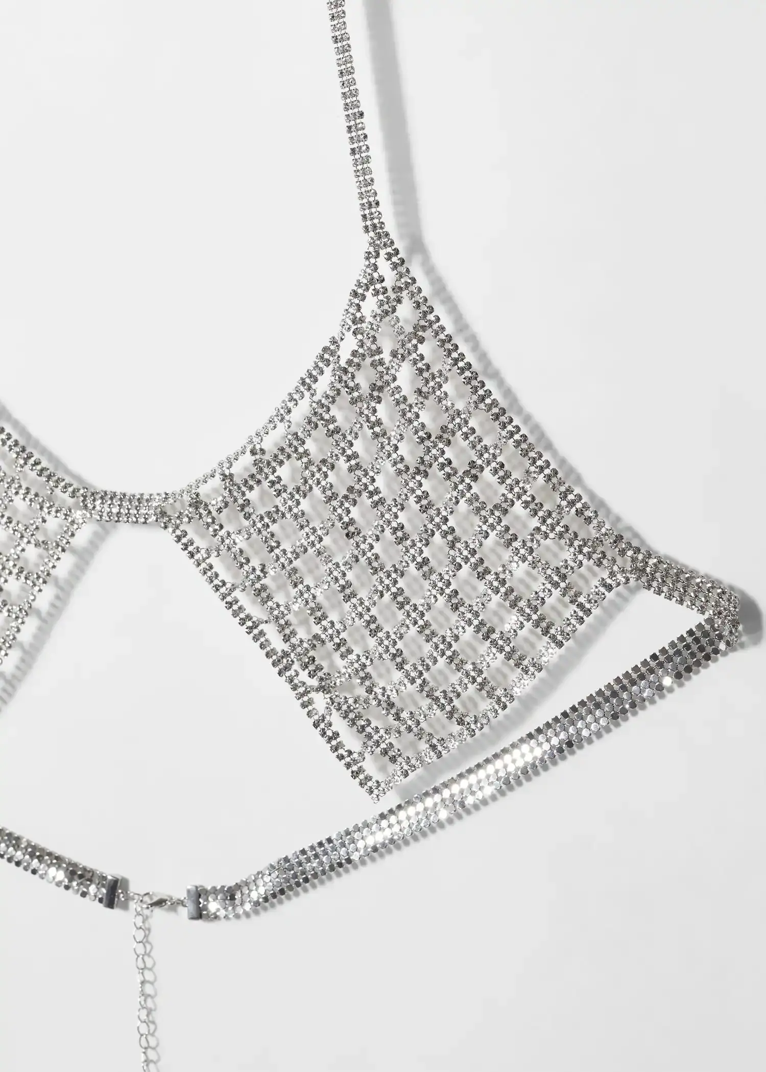Mango Metallic mesh bra. a close-up of a silver chain-link necklace. 