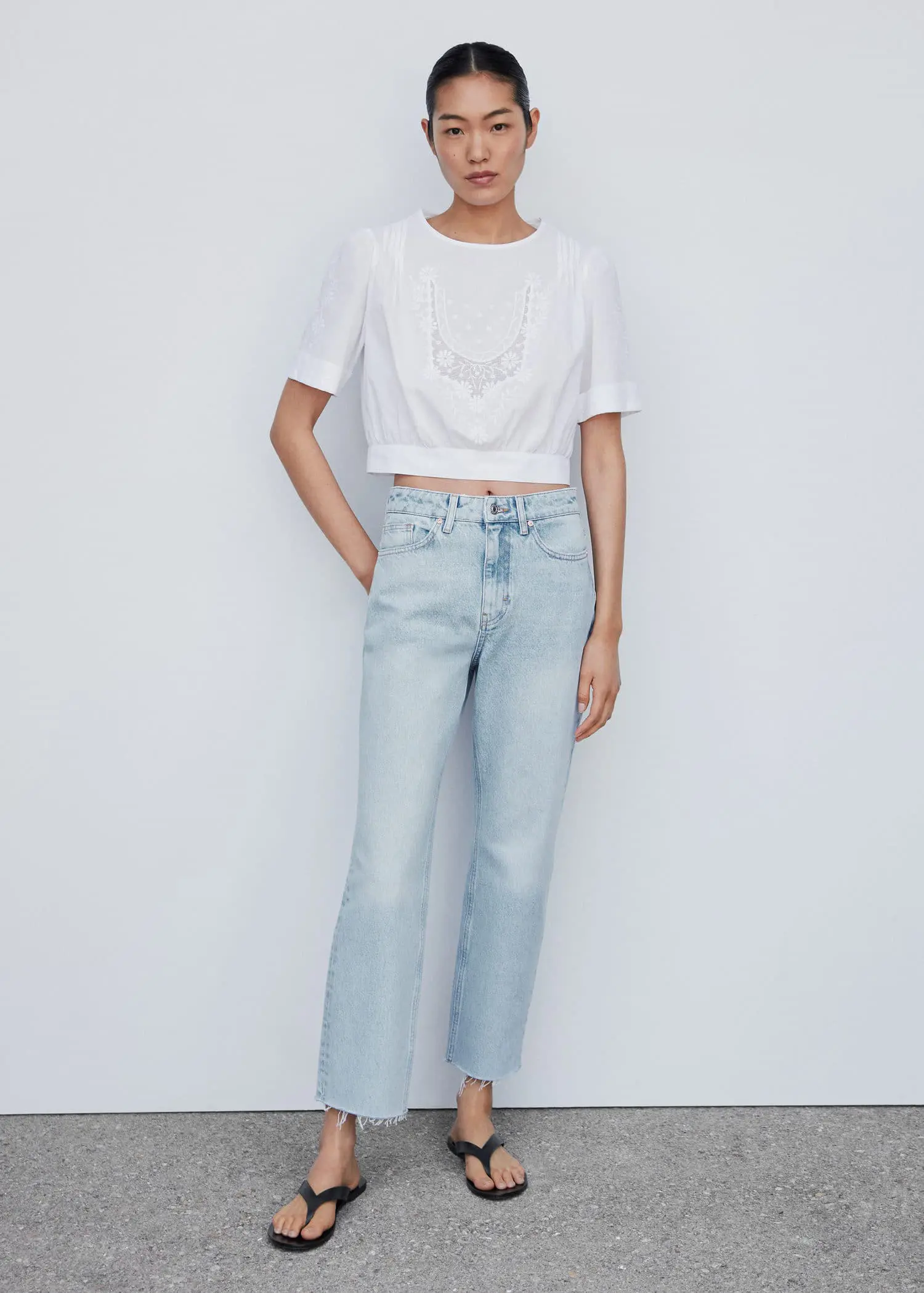 Mango High waist straight jeans. a person standing in front of a white wall. 
