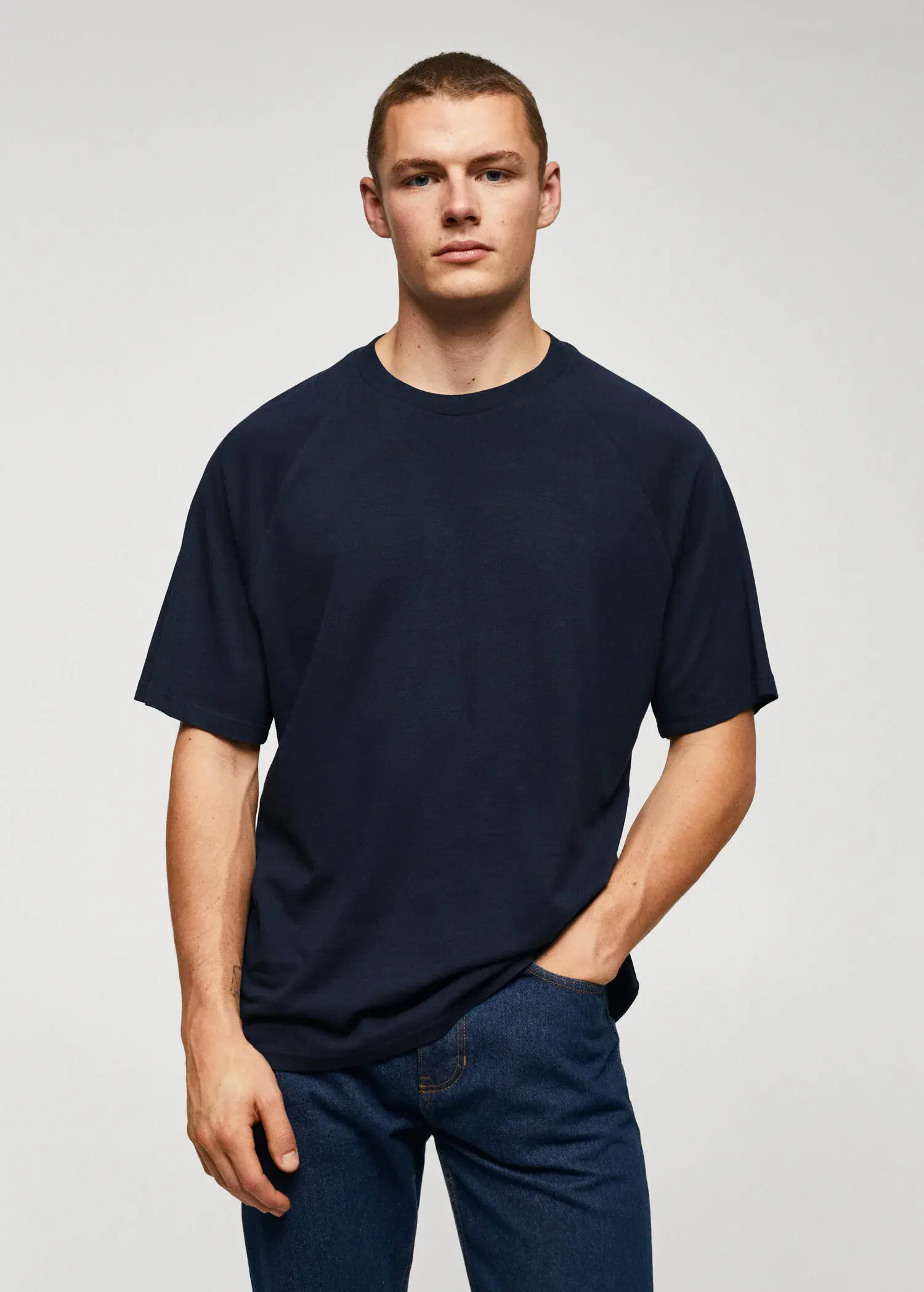 Mango Textured cotton-linen t-shirt. a young man wearing a black t-shirt and blue jeans. 