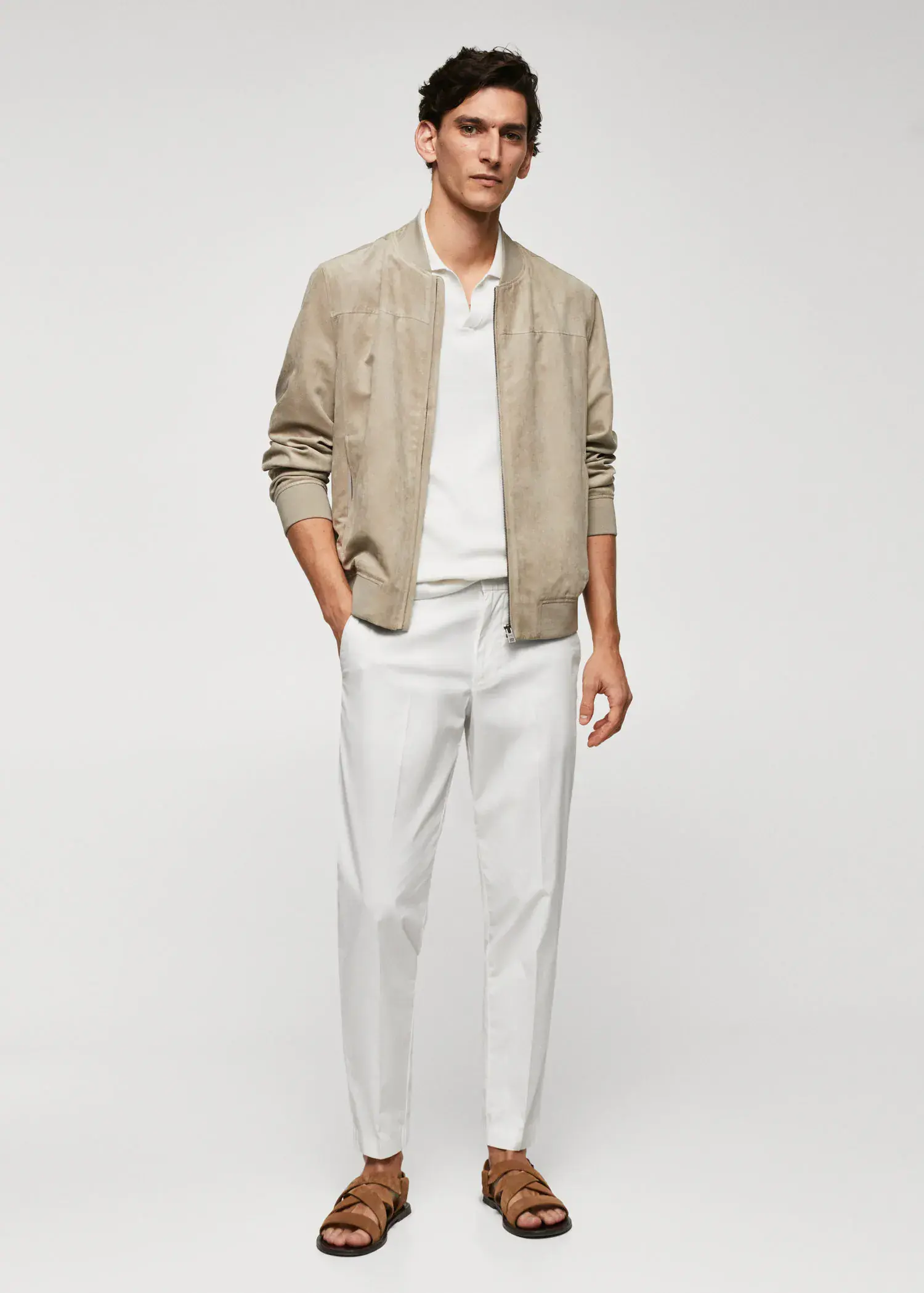 Mango Slim-fit cotton trousers. a man in a tan jacket and white pants. 