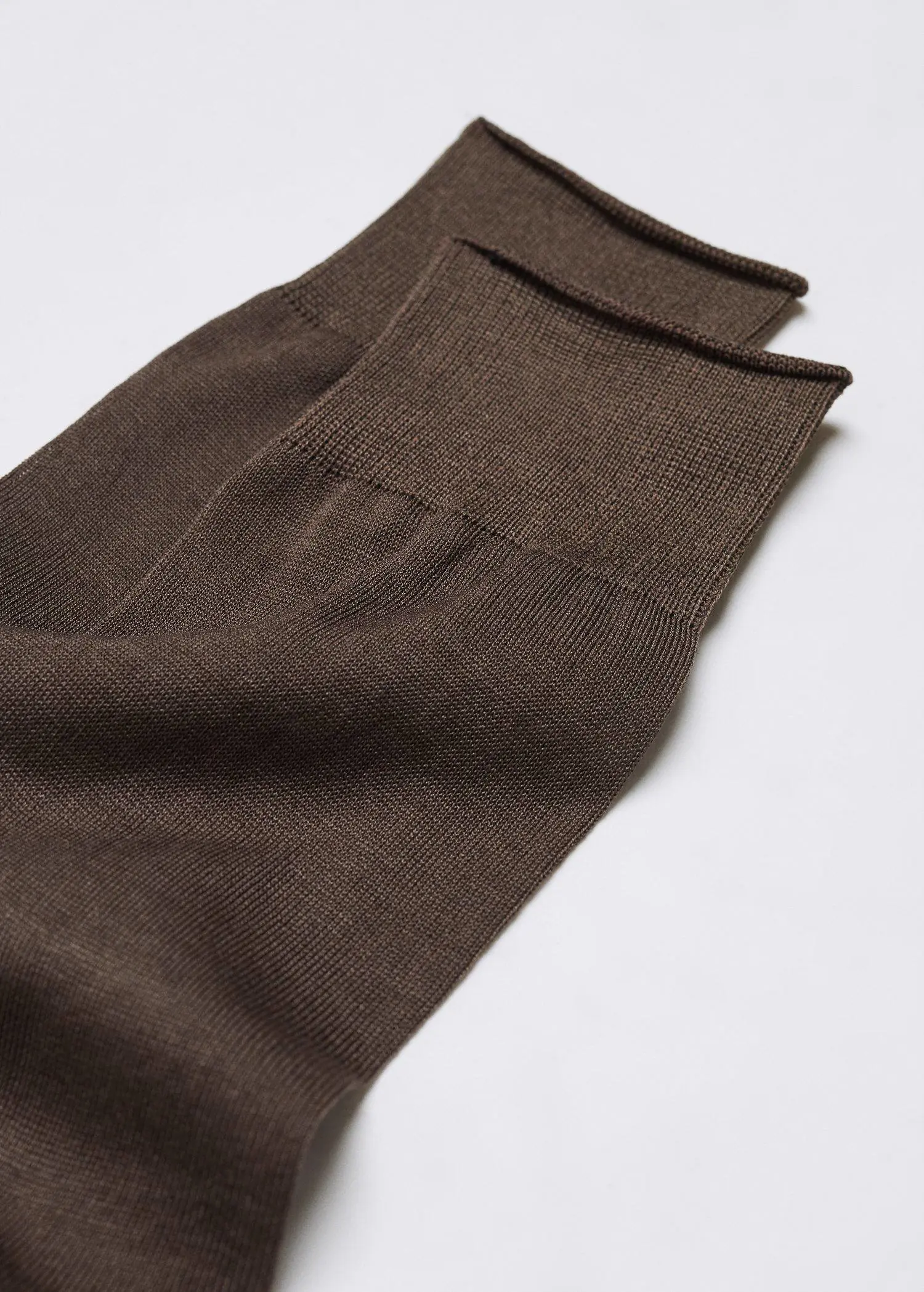 Mango 100% plain cotton socks. a pair of brown socks sitting on top of a white table. 