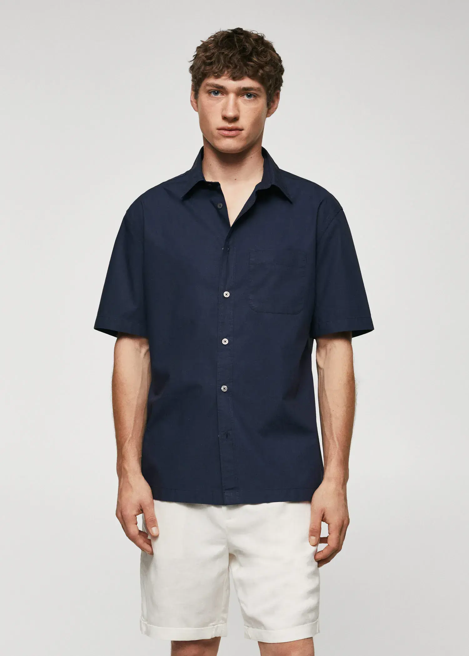Mango Regular-fit cotton short sleeve shirt. a man wearing a blue shirt and white shorts. 