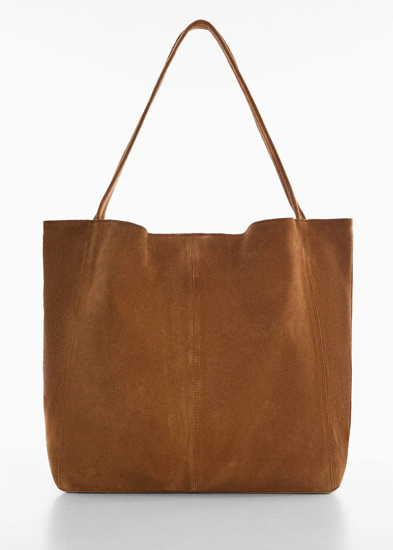 Mango Leather shopper bag. a brown leather bag hanging on a white wall. 