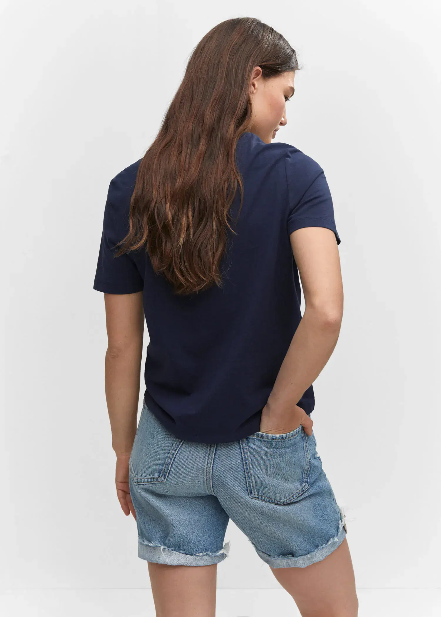 Mango Embroidered message T-shirt. a woman is standing with her hands in her pockets. 