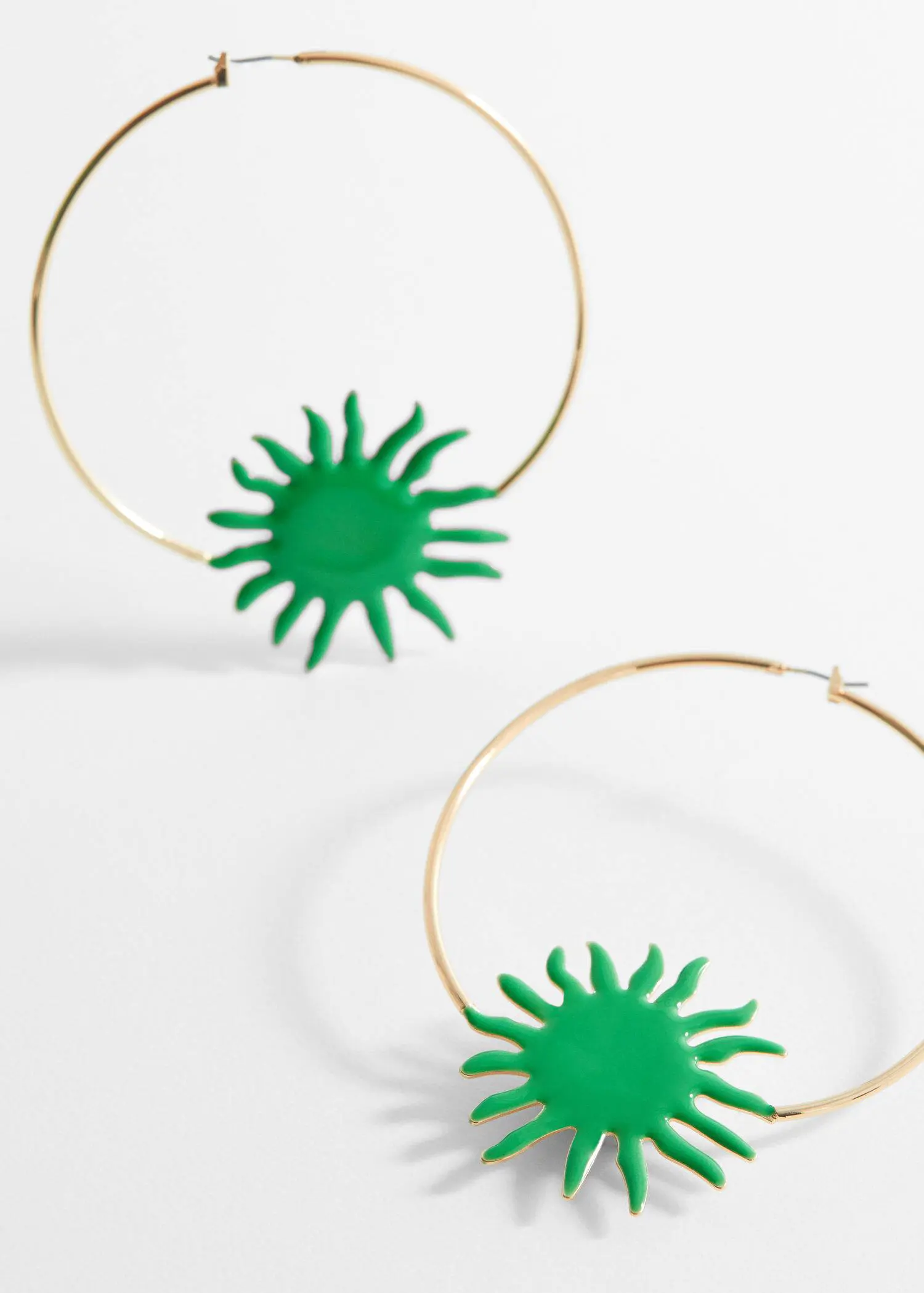 Mango Maxi hoop earrings. a close up of a pair of earrings on a table 