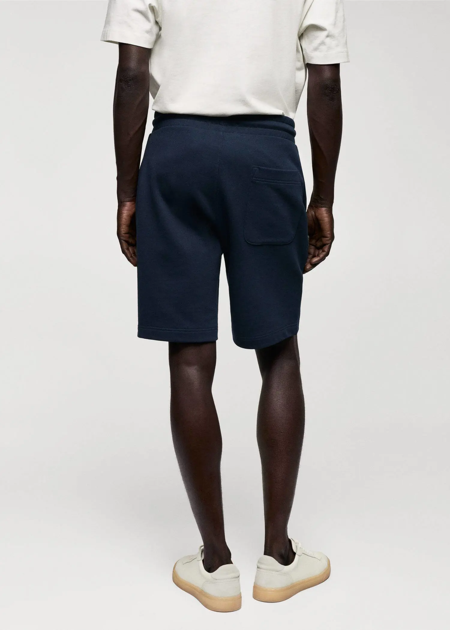 Mango Jogger cotton Bermuda shorts. a man wearing a pair of navy blue shorts. 