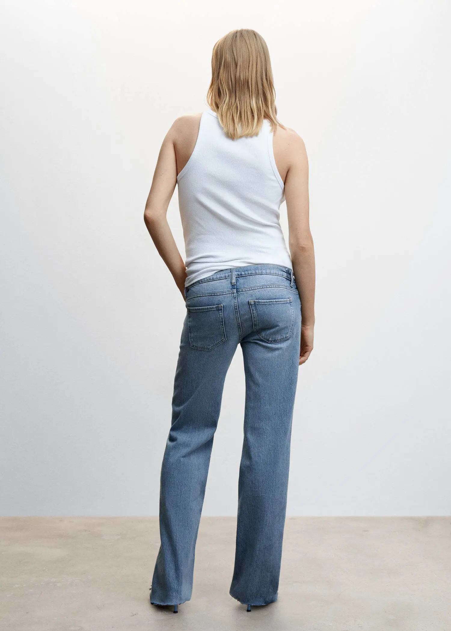 Mango Maternity wideleg jeans. a woman standing in front of a white wall. 