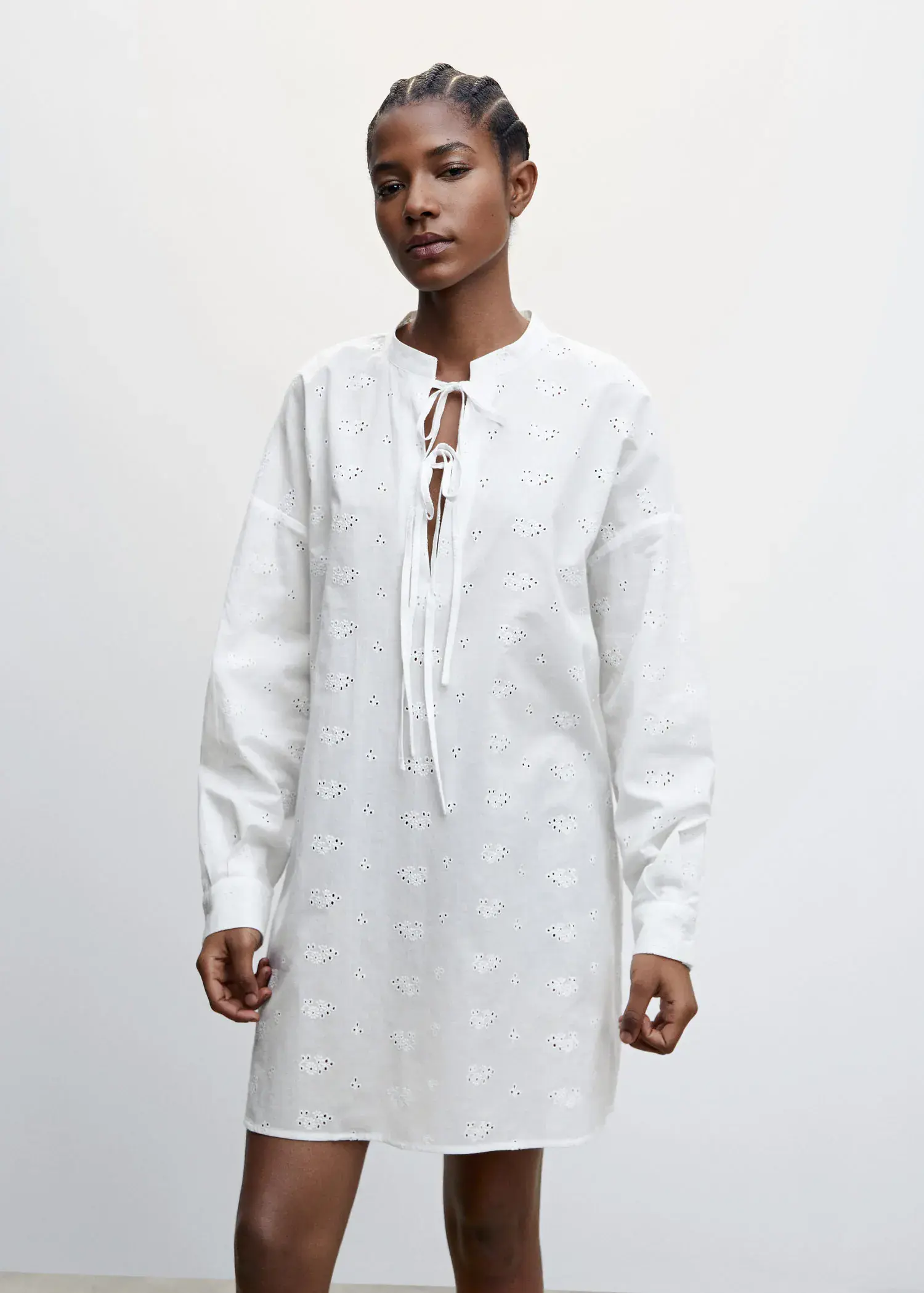Mango Cotton nightgown with openwork details. a person wearing a white dress standing in front of a wall. 