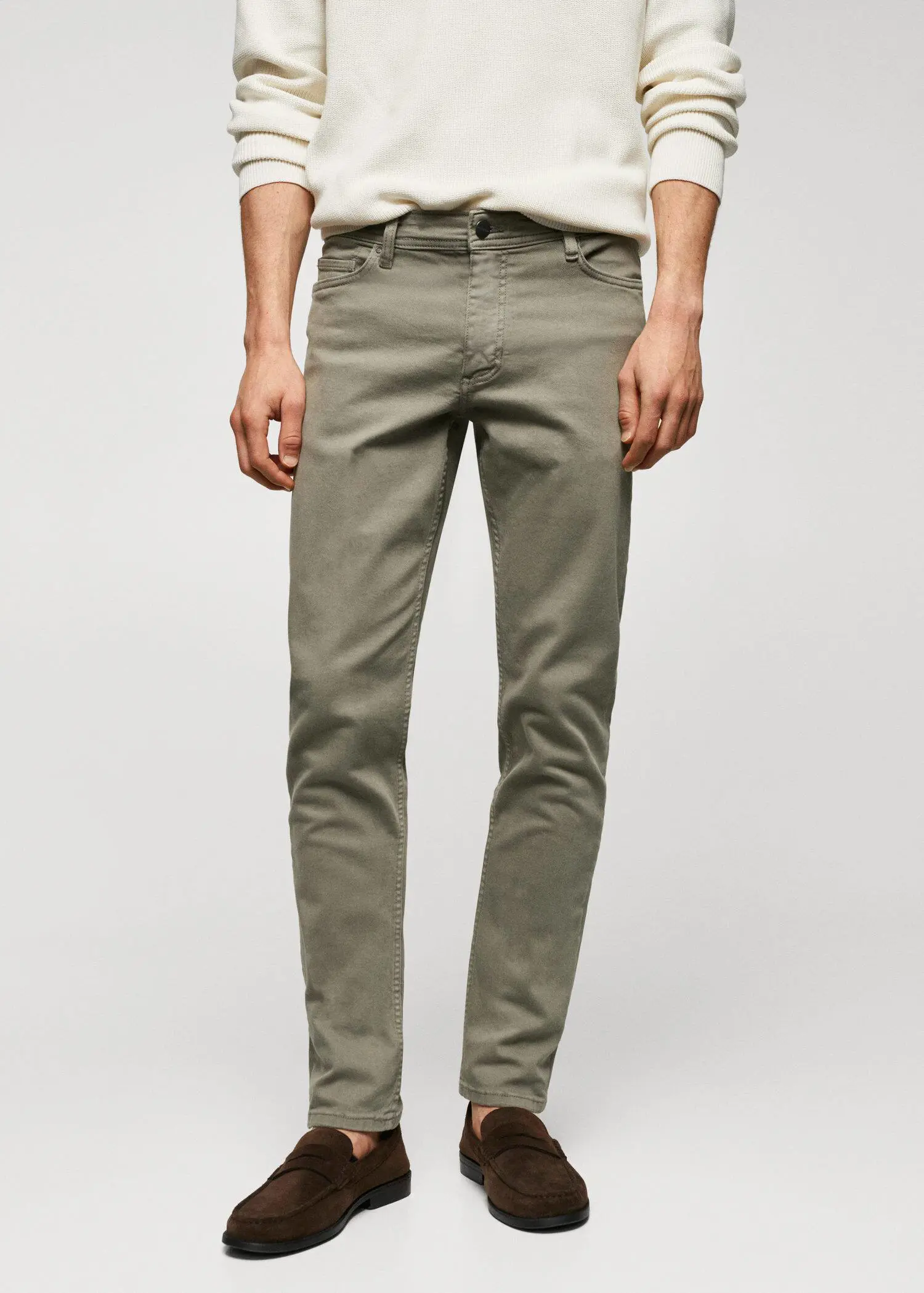 Mango Jan slim-fit jeans. a person wearing a pair of green pants. 